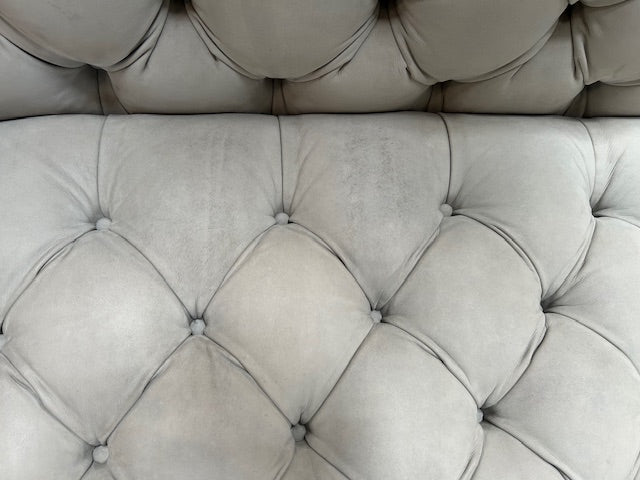 A white Baxter Chester Moon Sofa with a tufted back.