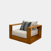 The Harbour Hayman Teak Outdoor Swivel Lounge Chair by Harbour features a modern design with a light beige cushion and a black-and-white patterned throw pillow, shown against a plain white background.