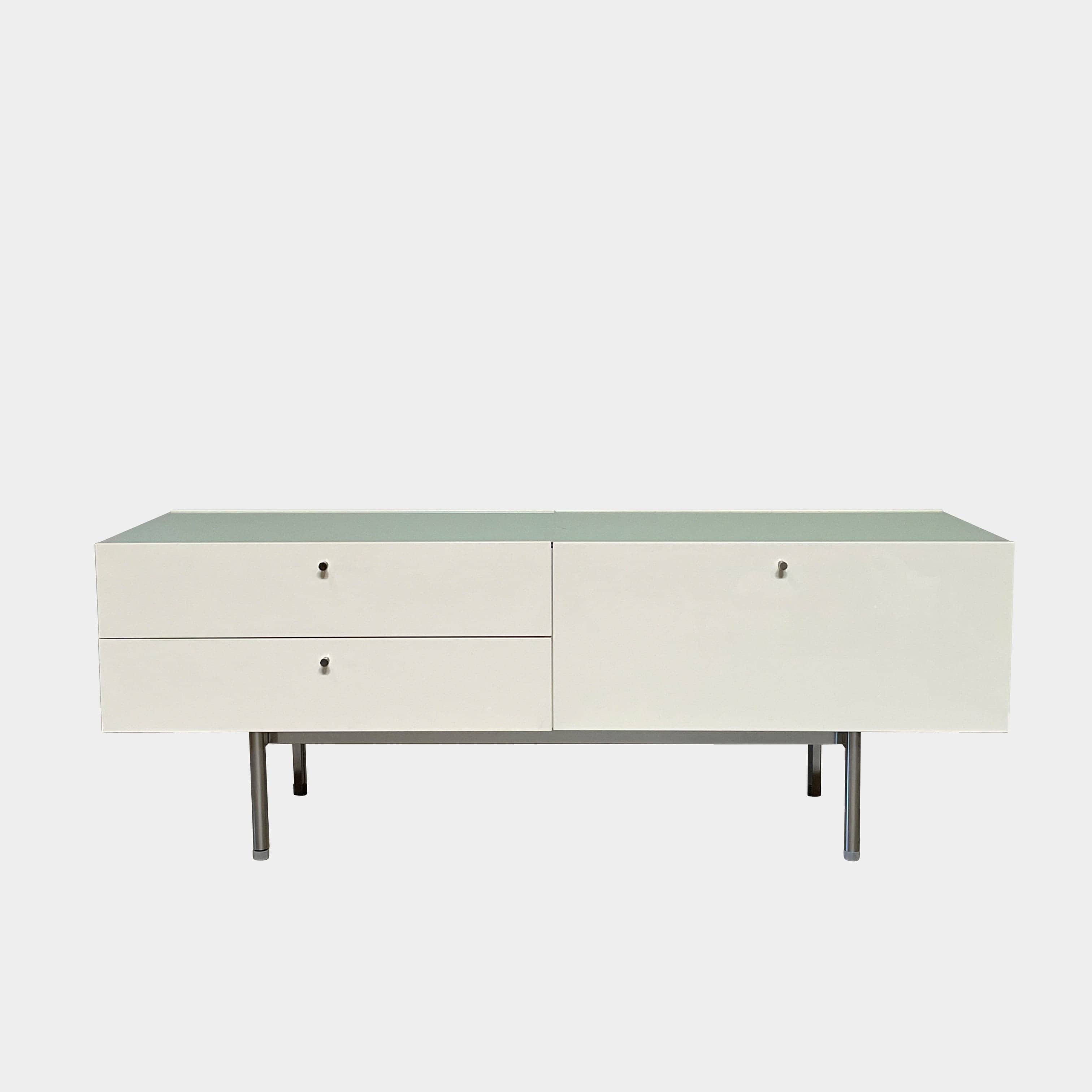 The Cassina 255-256 Flat Sideboard in glossy white lacquer features two left drawers, a spacious right compartment, and four metal legs, all by Cassina, shown against a plain background.