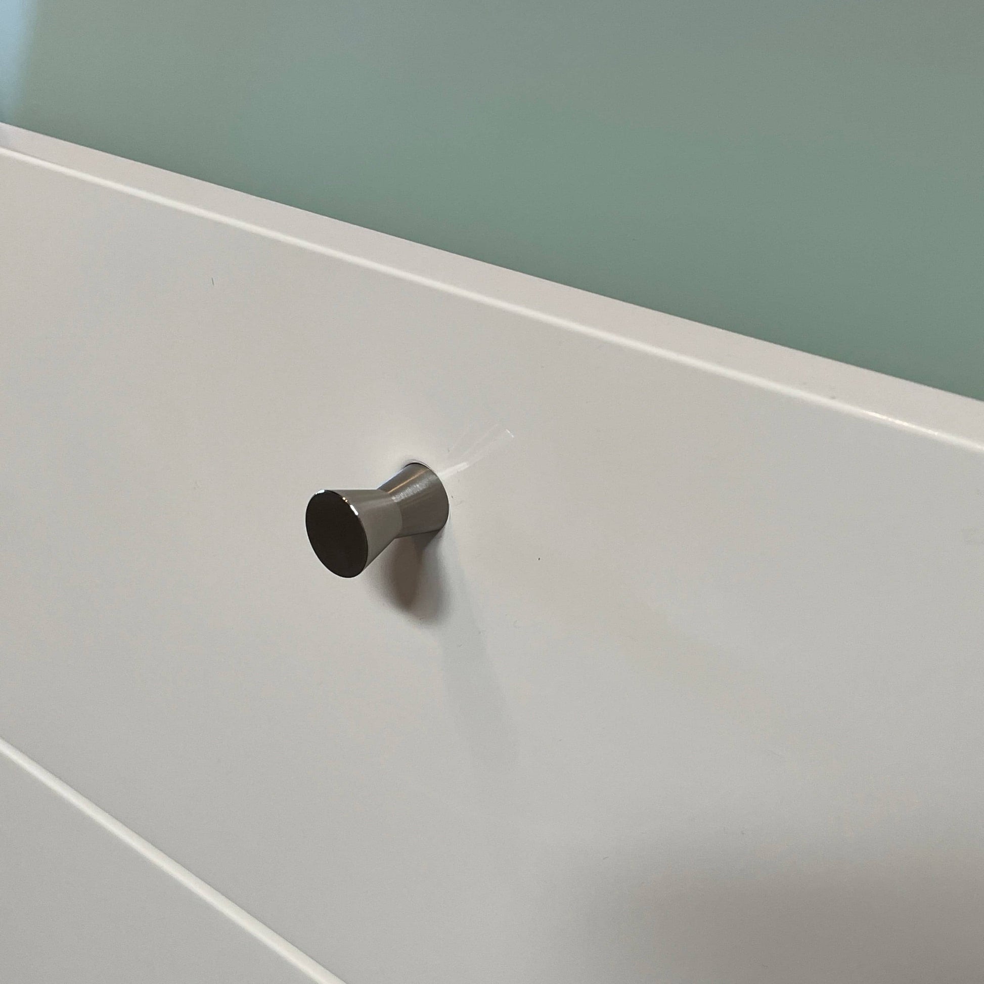 The Cassina 255-256 Flat Sideboard in glossy white lacquer features two left drawers, a spacious right compartment, and four metal legs, all by Cassina, shown against a plain background.