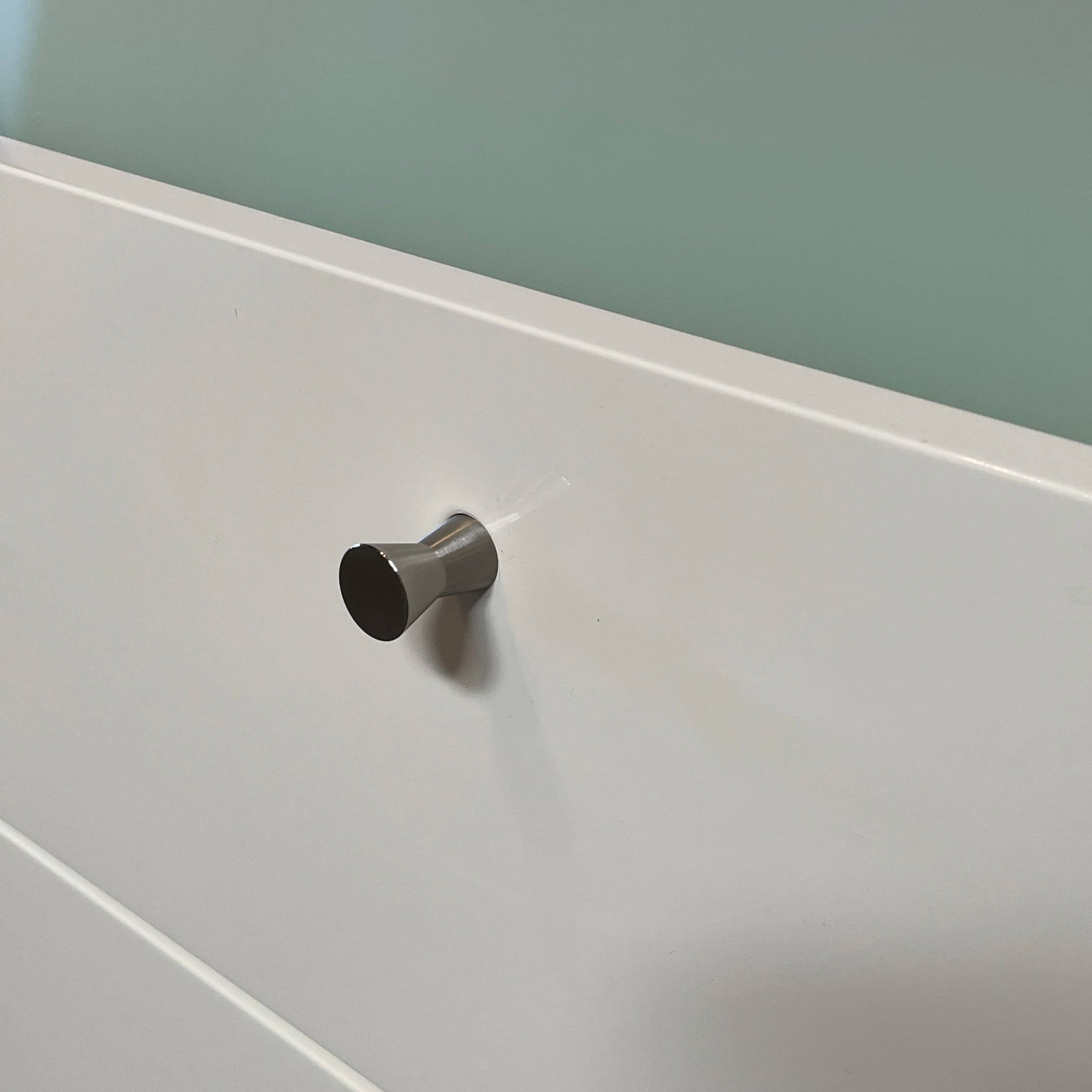 The Cassina 255-256 Flat Sideboard in glossy white lacquer features two left drawers, a spacious right compartment, and four metal legs, all by Cassina, shown against a plain background.