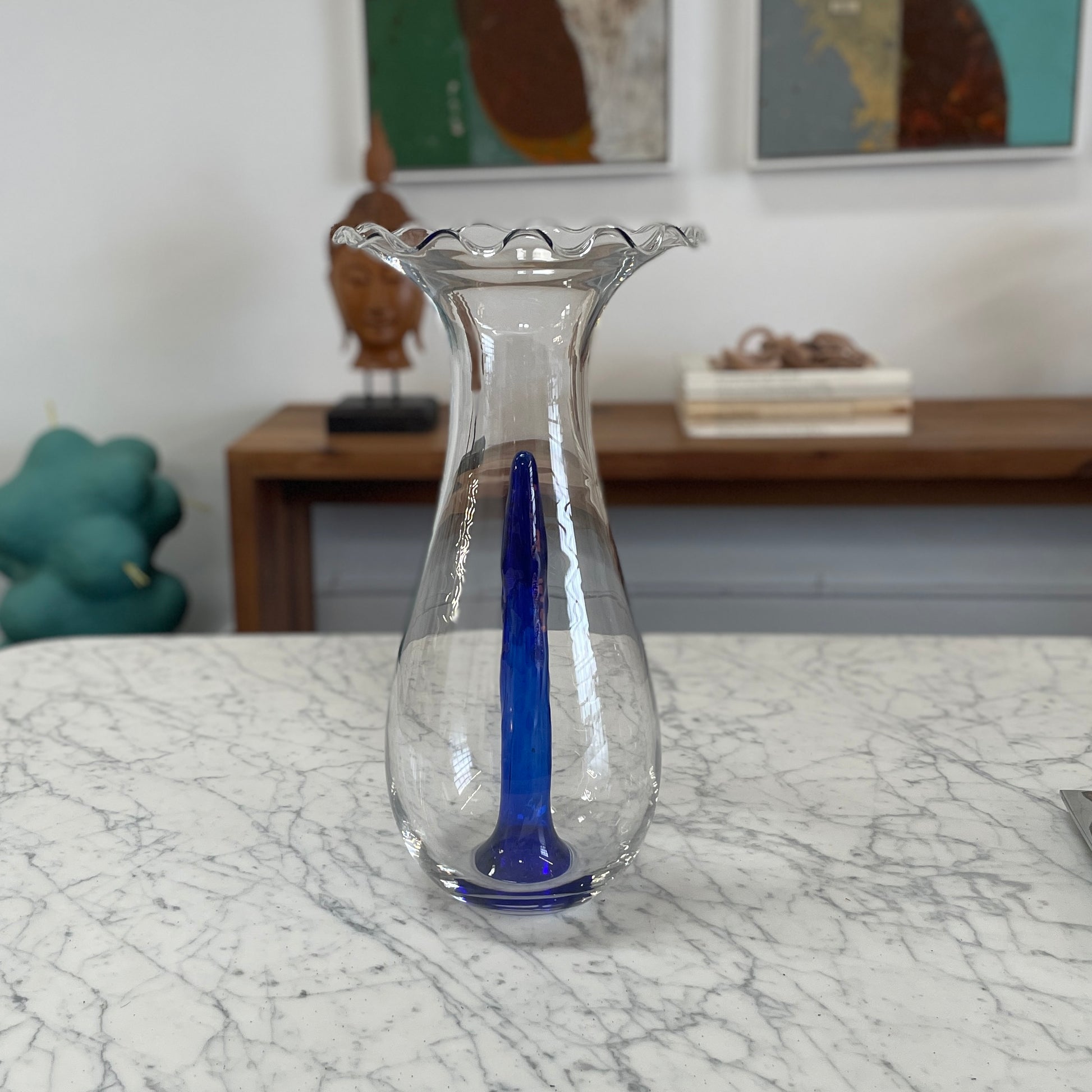 Reminiscent of Philippe Starck's elegance, the Driade Gabriel Vase by Driade showcases a wavy rim and a striking blue vertical streak within its transparent body, capturing sophisticated simplicity.