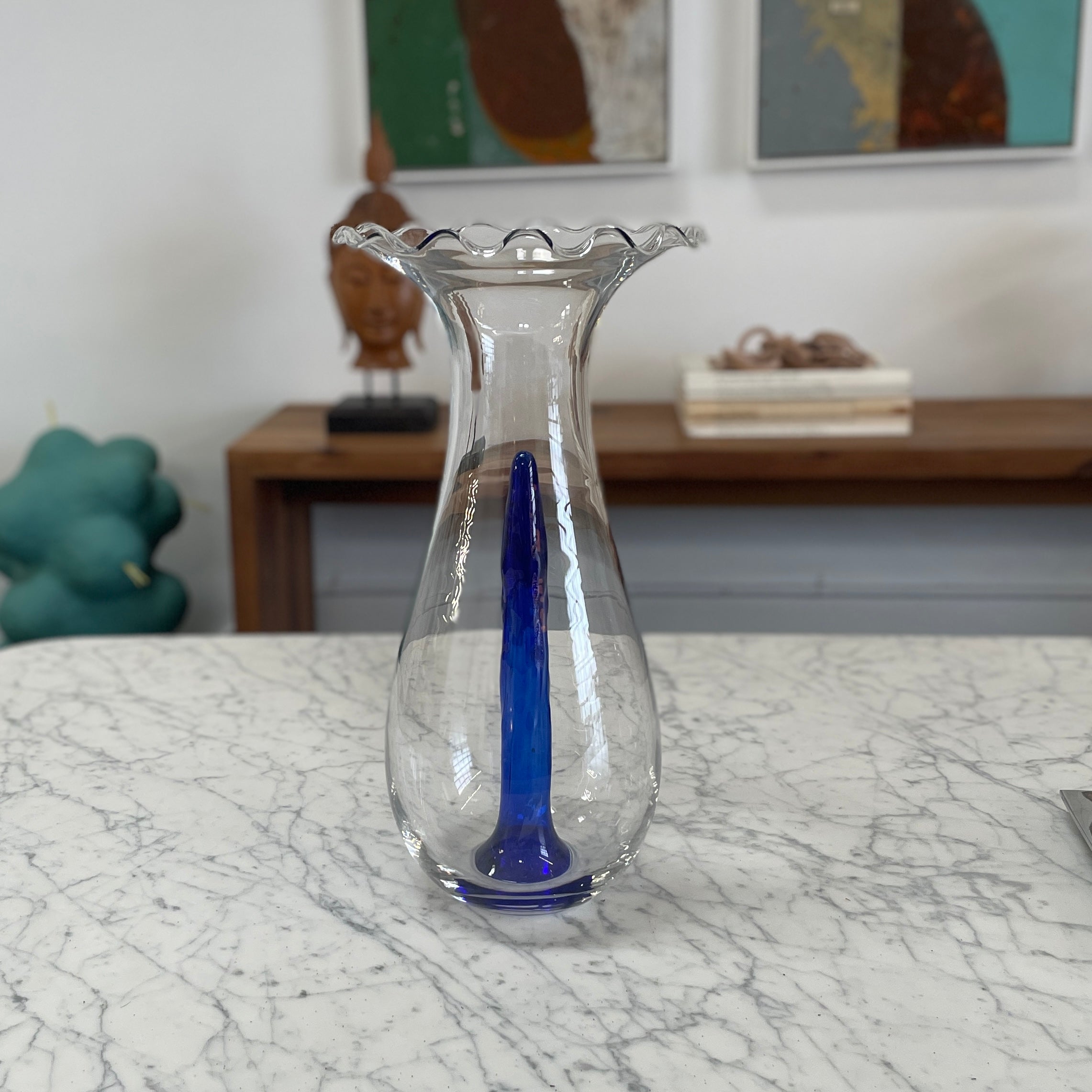Reminiscent of Philippe Starck's elegance, the Driade Gabriel Vase by Driade showcases a wavy rim and a striking blue vertical streak within its transparent body, capturing sophisticated simplicity.