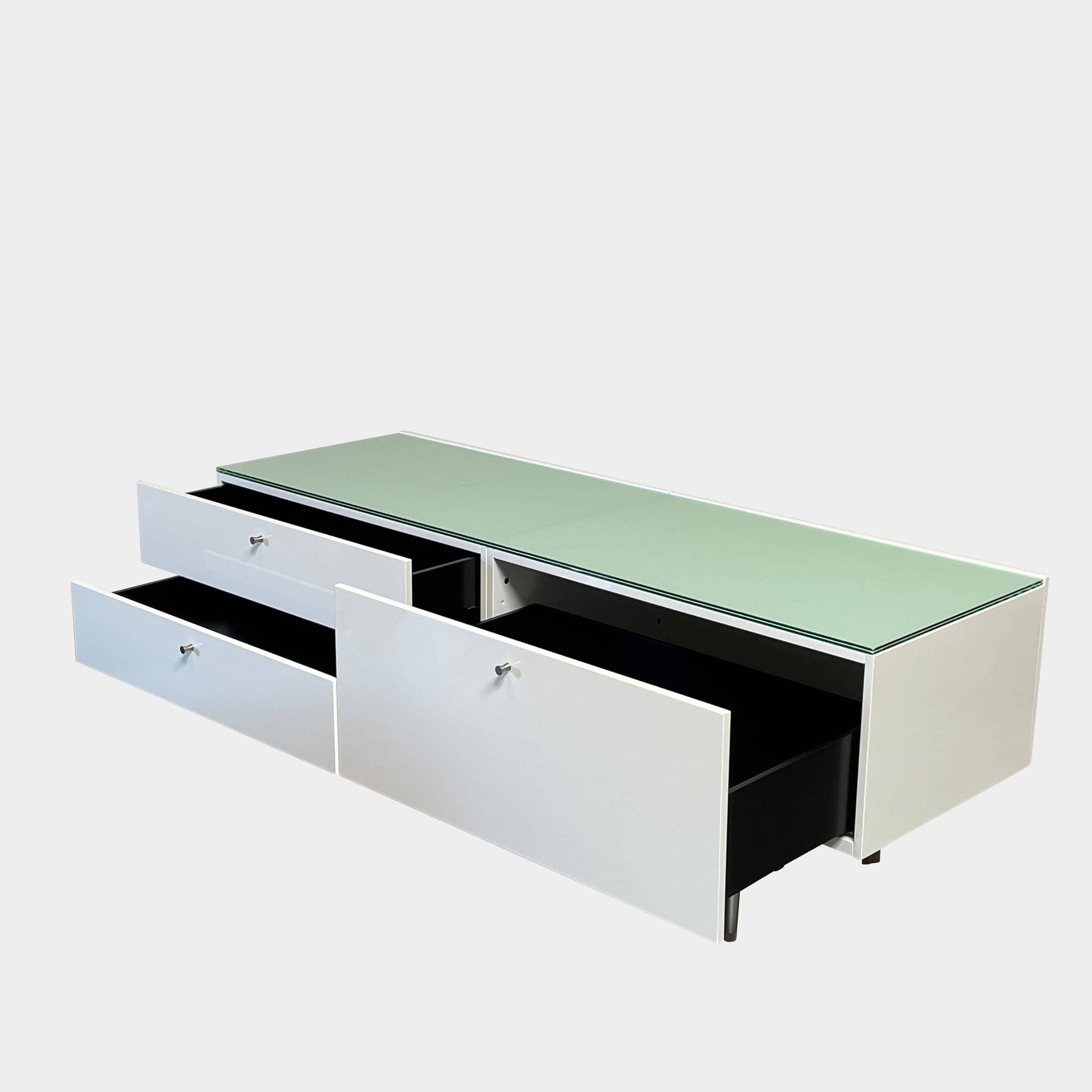 The Cassina 255-256 Flat Sideboard in glossy white lacquer features two left drawers, a spacious right compartment, and four metal legs, all by Cassina, shown against a plain background.