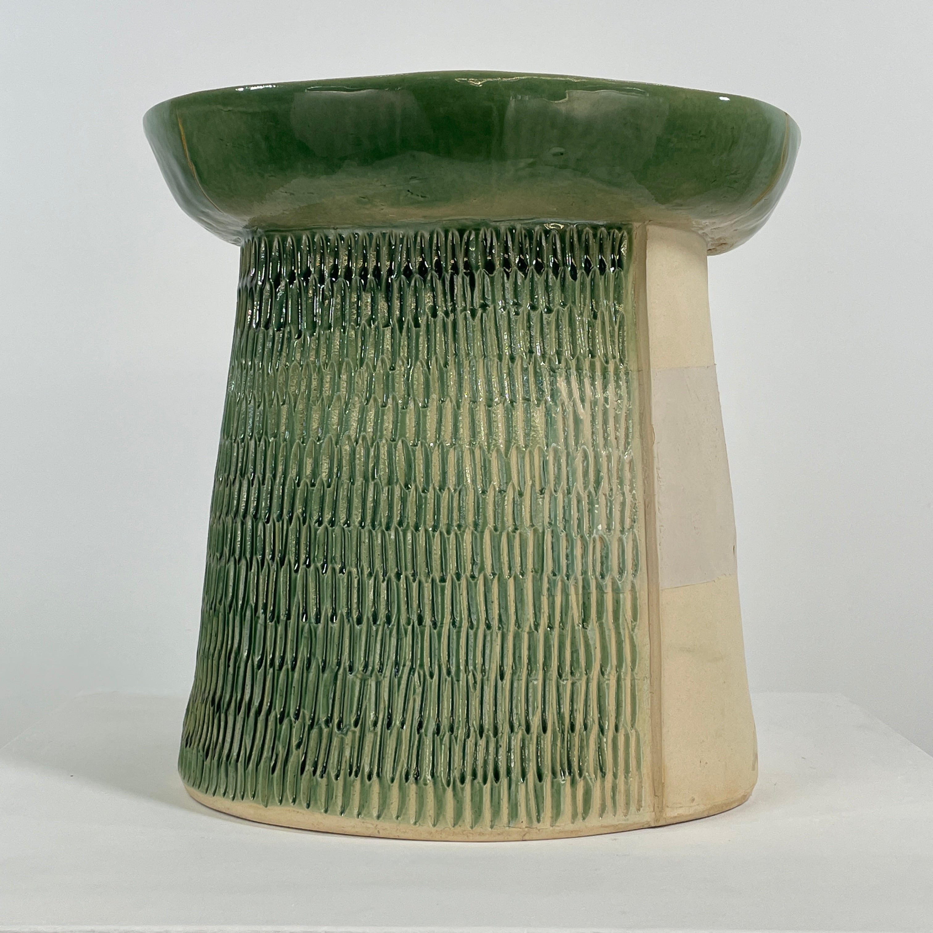 The Artist Allyn Davis Ceramic Side Table in Celadon features a textured cylindrical base and smooth round top, all on a plain white background.