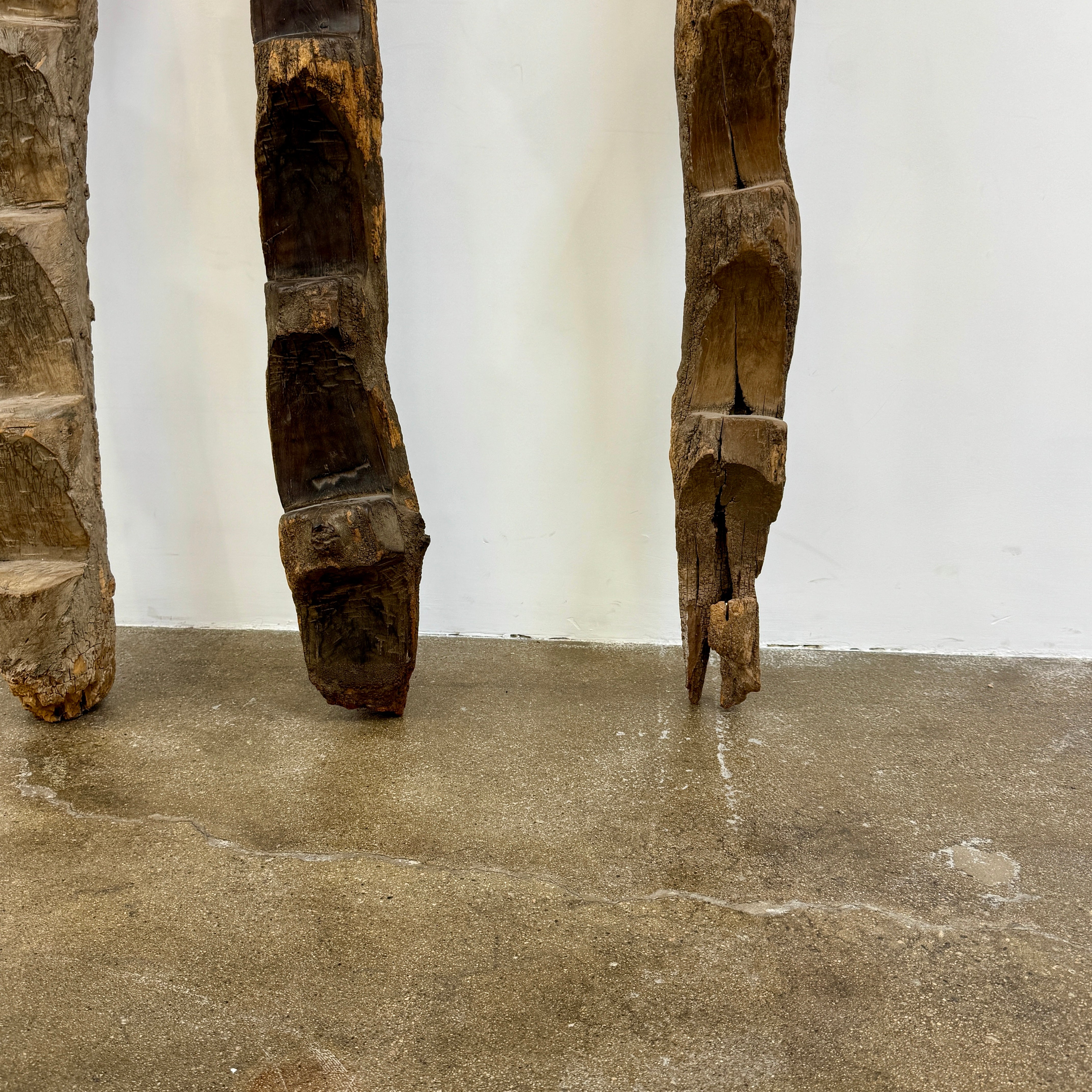 Four Vintage African Dogan Ladders, sold separately, feature wooden sticks with forked tops arranged vertically against a plain white background, showcasing distinctive African craftsmanship.