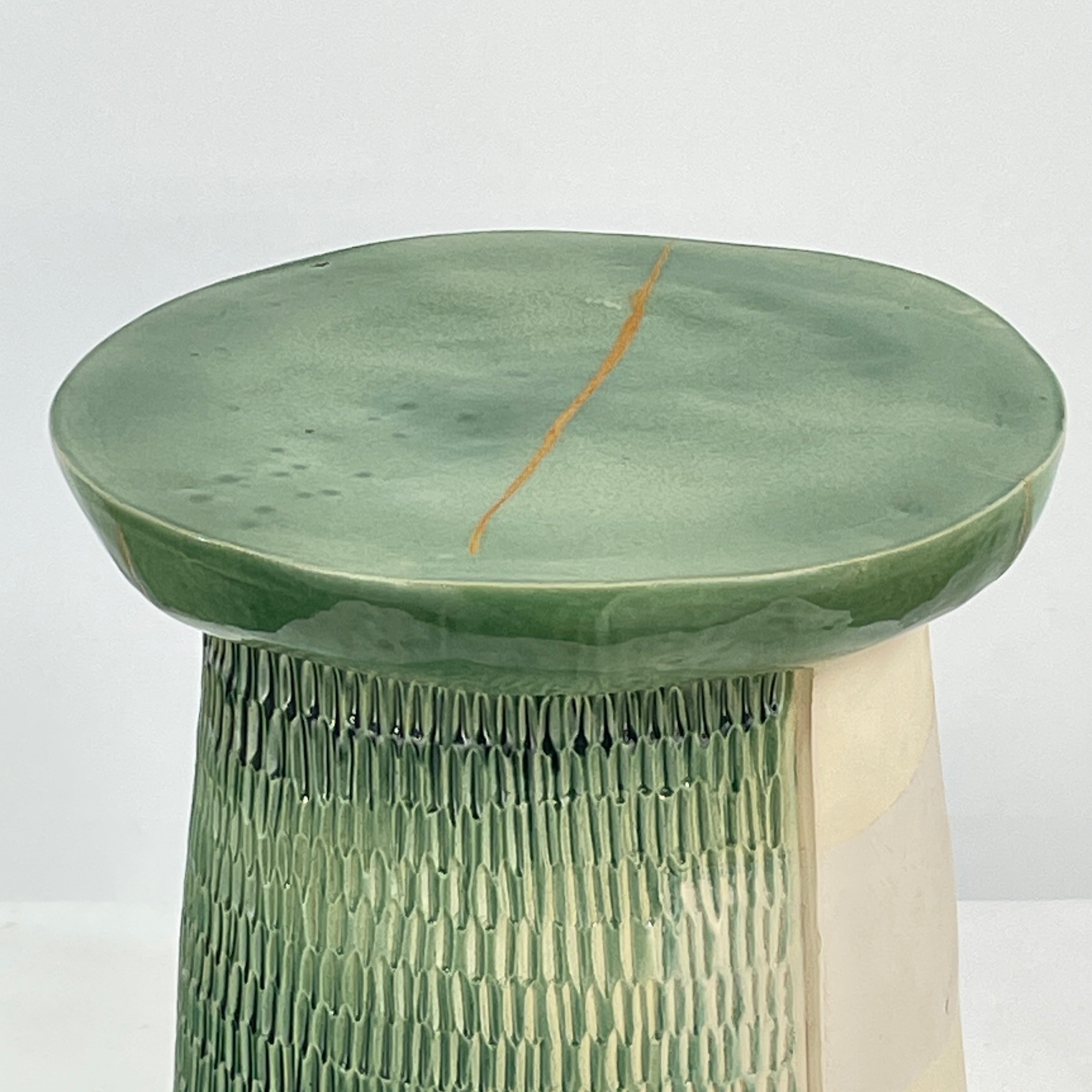 The Artist Allyn Davis Ceramic Side Table in Celadon features a textured cylindrical base and smooth round top, all on a plain white background.