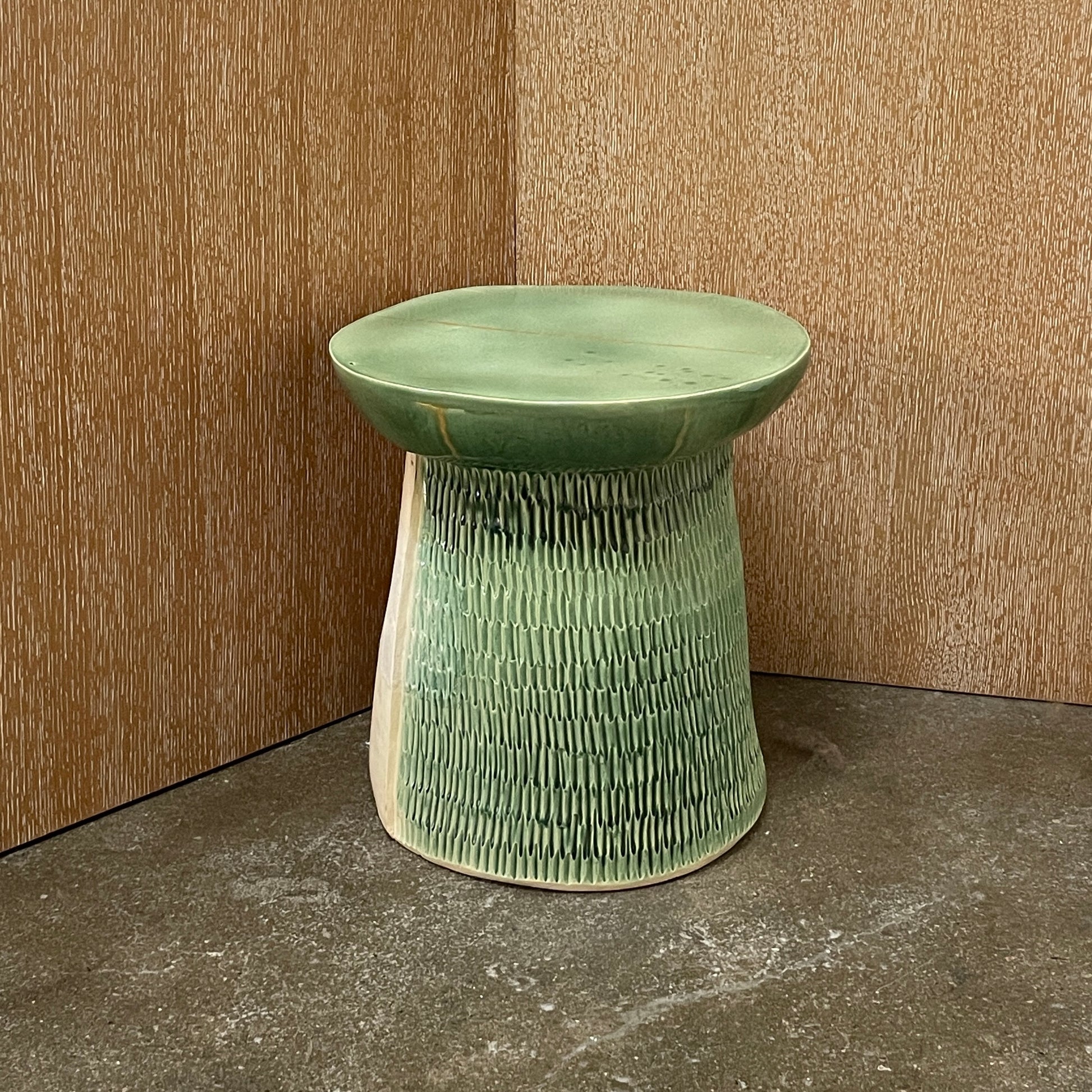 The Artist Allyn Davis Ceramic Side Table in Celadon features a textured cylindrical base and smooth round top, all on a plain white background.
