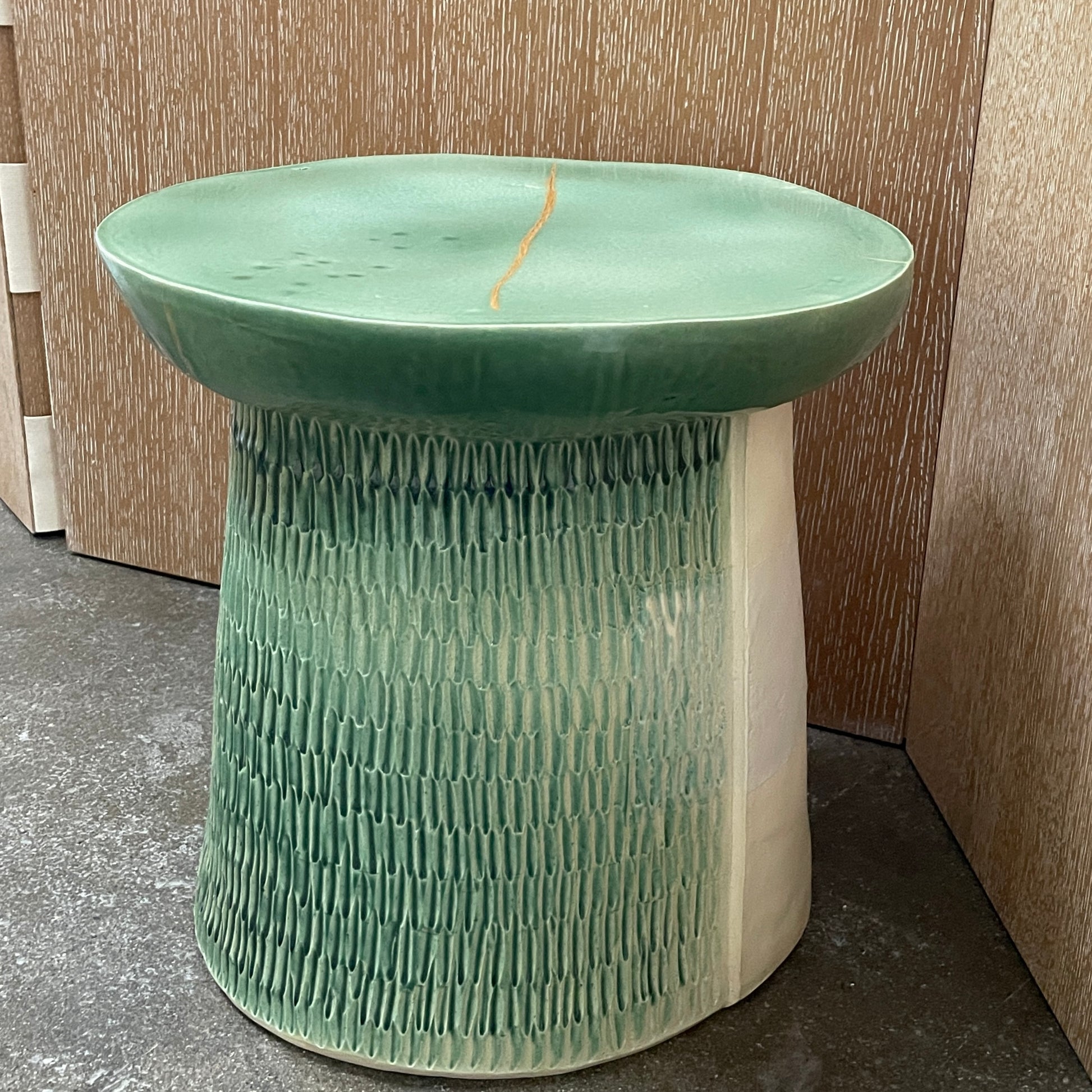 The Artist Allyn Davis Ceramic Side Table in Celadon features a textured cylindrical base and smooth round top, all on a plain white background.