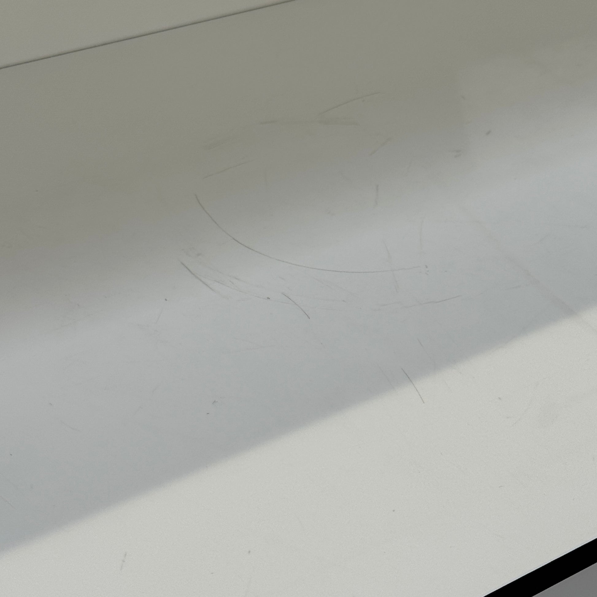 Two long, empty black shelves from the B&B Italia PAB Shelving collection are mounted on a white wall, supported by evenly spaced metal brackets.