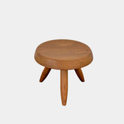 The Cassina “524 Tabouret Berger” stool by Cassina, crafted in walnut with three tapered legs and a round seat, is shown against a plain white background.