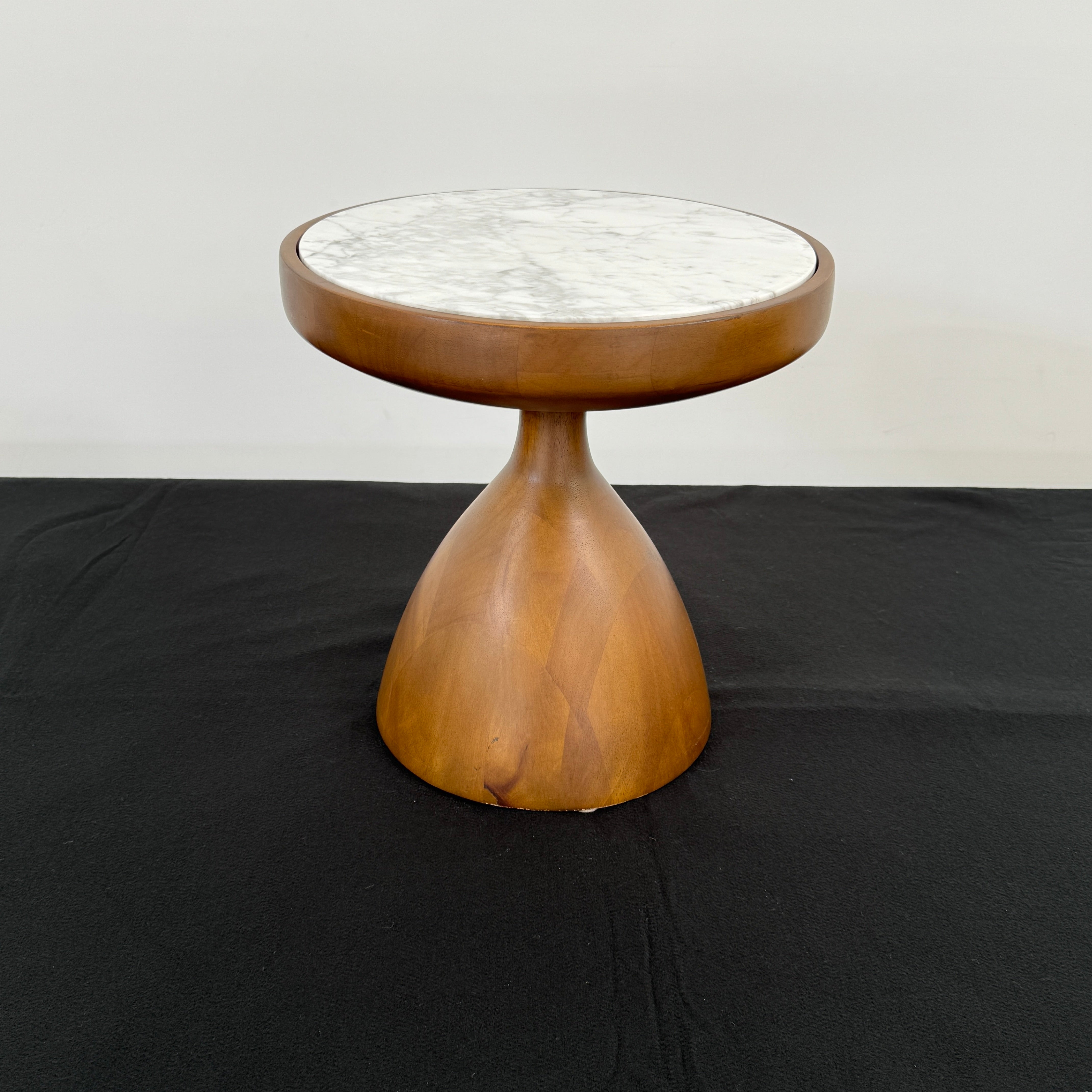 The Jonathan Adler Buenos Aires Side Table features a small round marble top and a sturdy wooden base, shown against a plain white background.