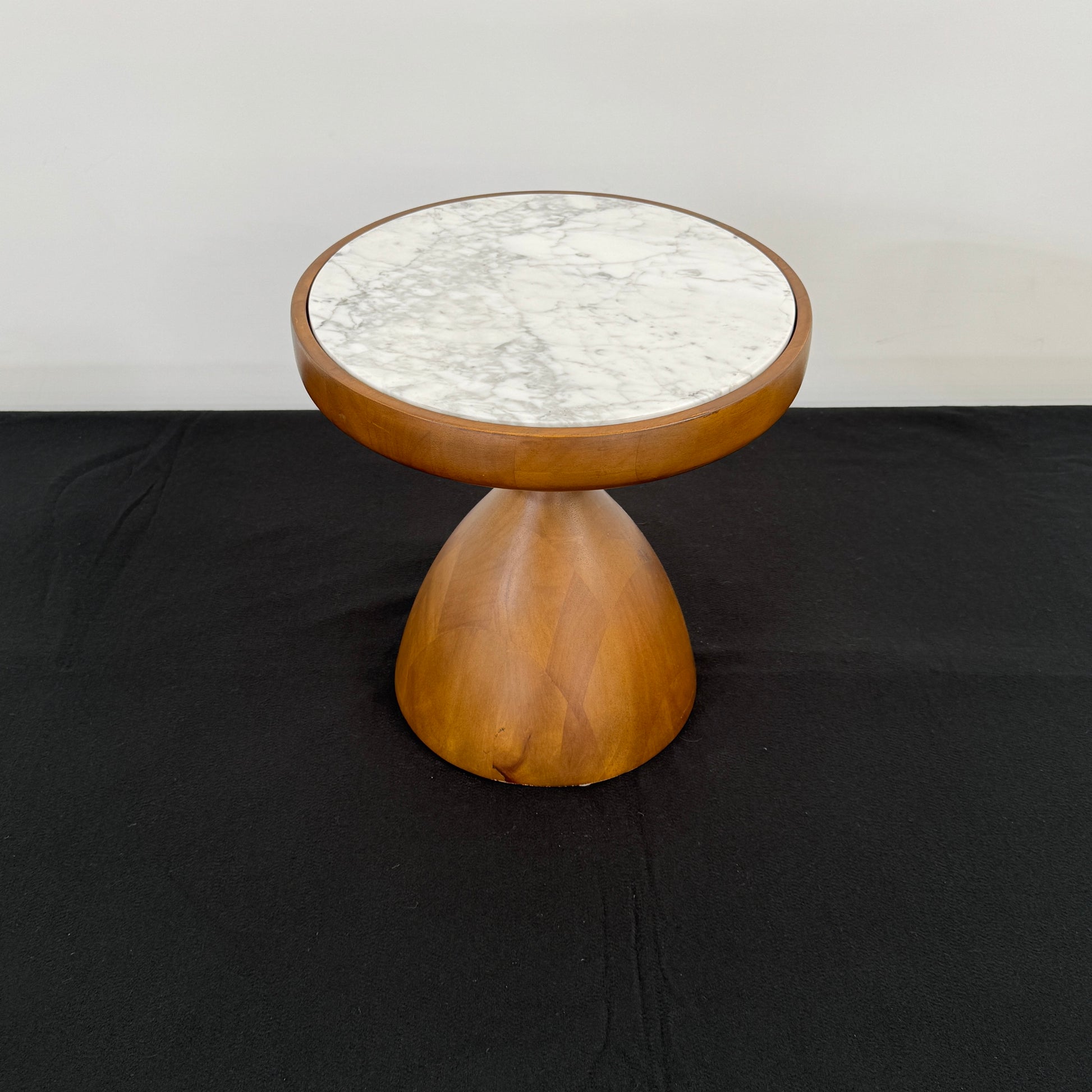 The Jonathan Adler Buenos Aires Side Table features a small round marble top and a sturdy wooden base, shown against a plain white background.