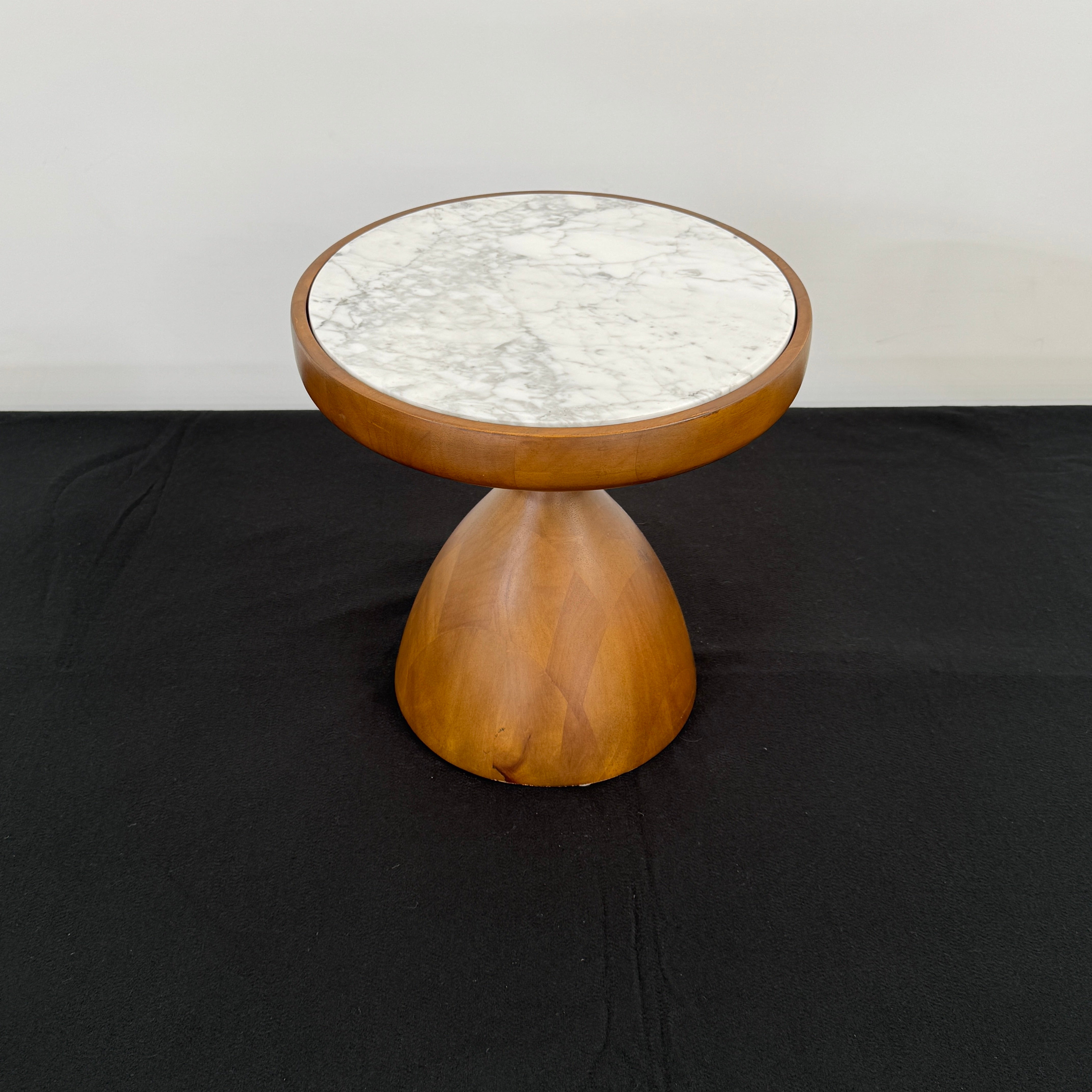 The Jonathan Adler Buenos Aires Side Table features a small round marble top and a sturdy wooden base, shown against a plain white background.