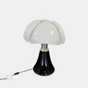 The Martinelli Luce Pipistrello Table Lamp by Martinelli Luce features a black base, silver neck, and white dome-shaped shade, shown against a plain white background with visible power cord and tag.