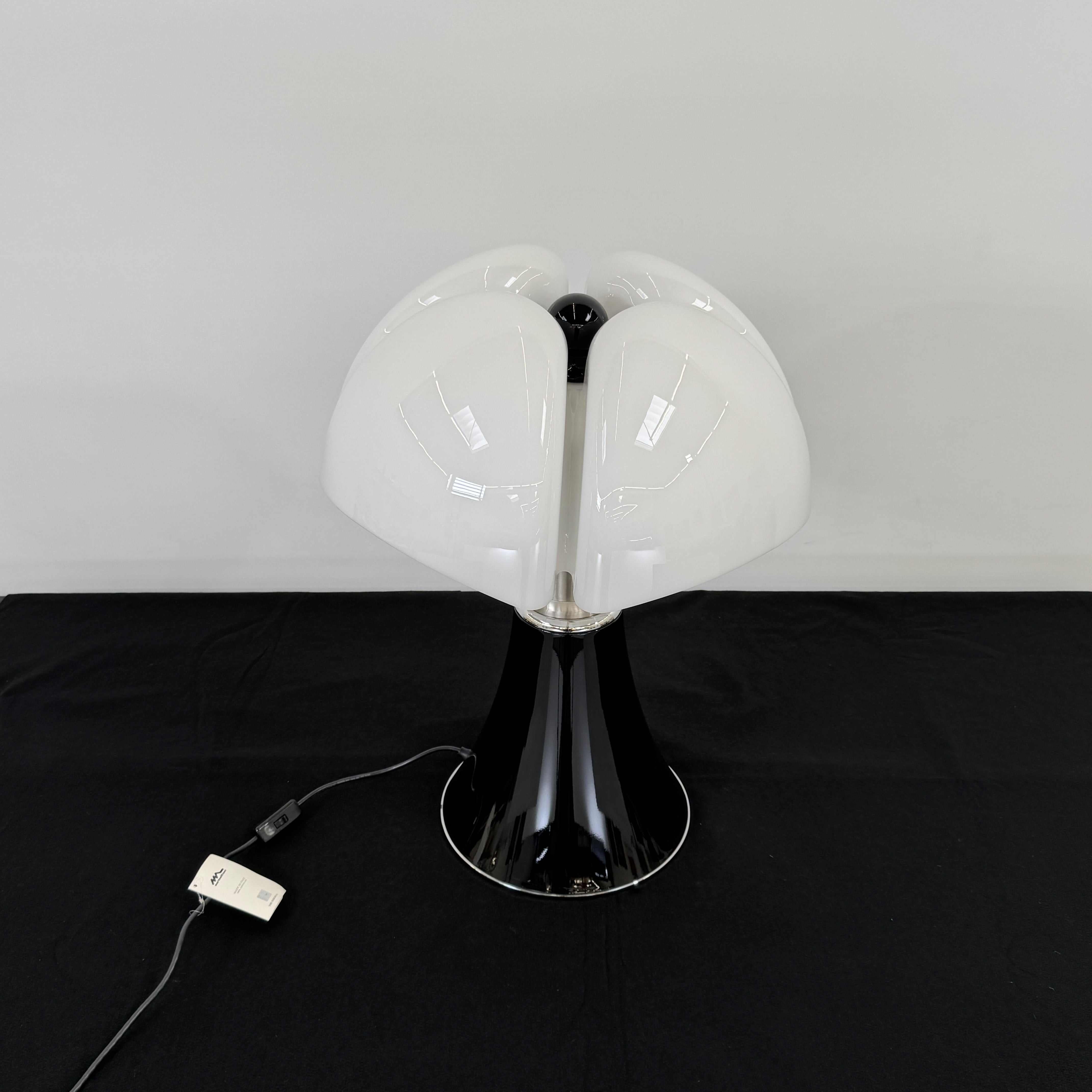 The Martinelli Luce Pipistrello Table Lamp by Martinelli Luce features a black base, silver neck, and white dome-shaped shade, shown against a plain white background with visible power cord and tag.