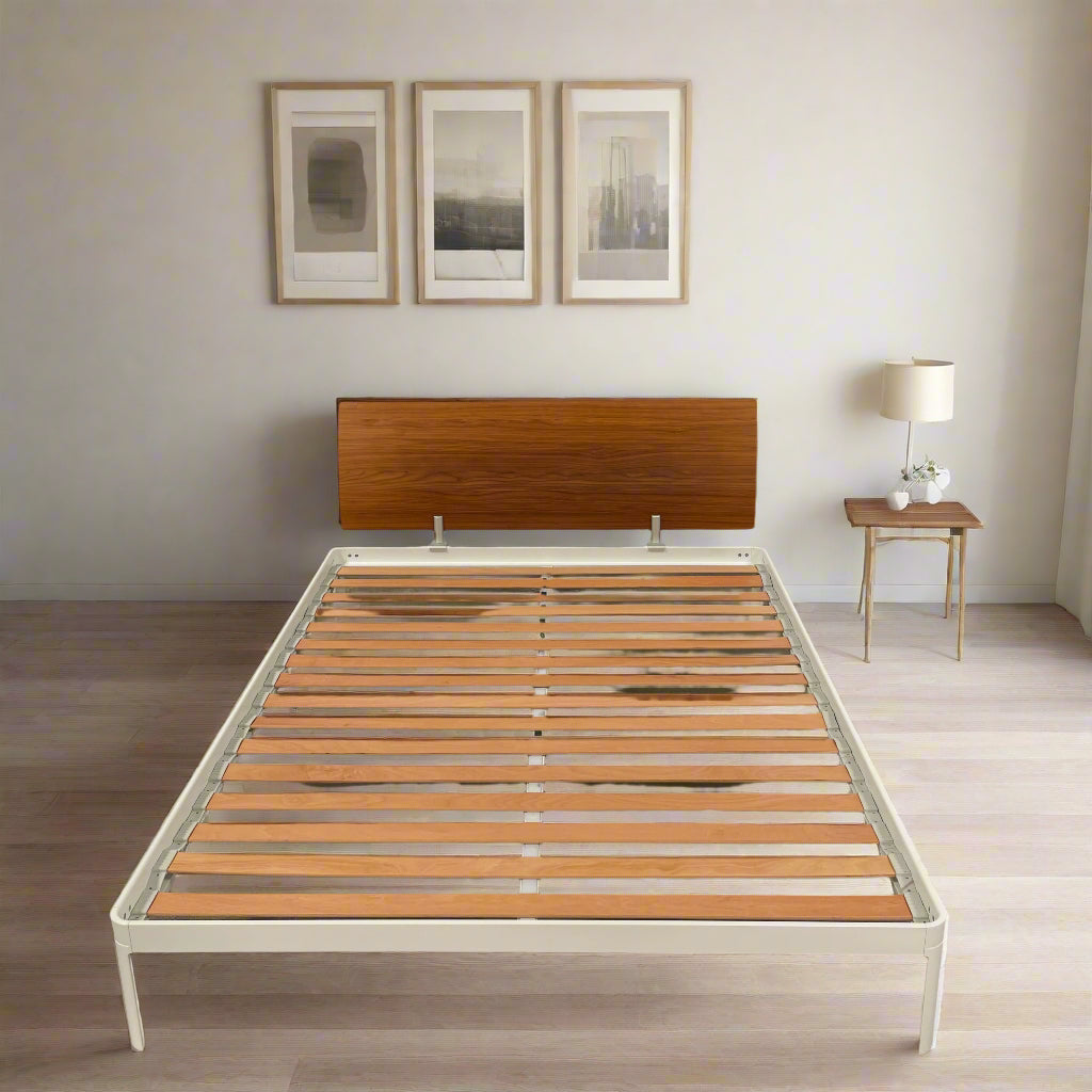 The DWR Min Queen Size Bed by Luciano Bertoncini showcases a metal frame with a sophisticated wooden headboard and slatted wooden base, elegantly placed against a plain white background.