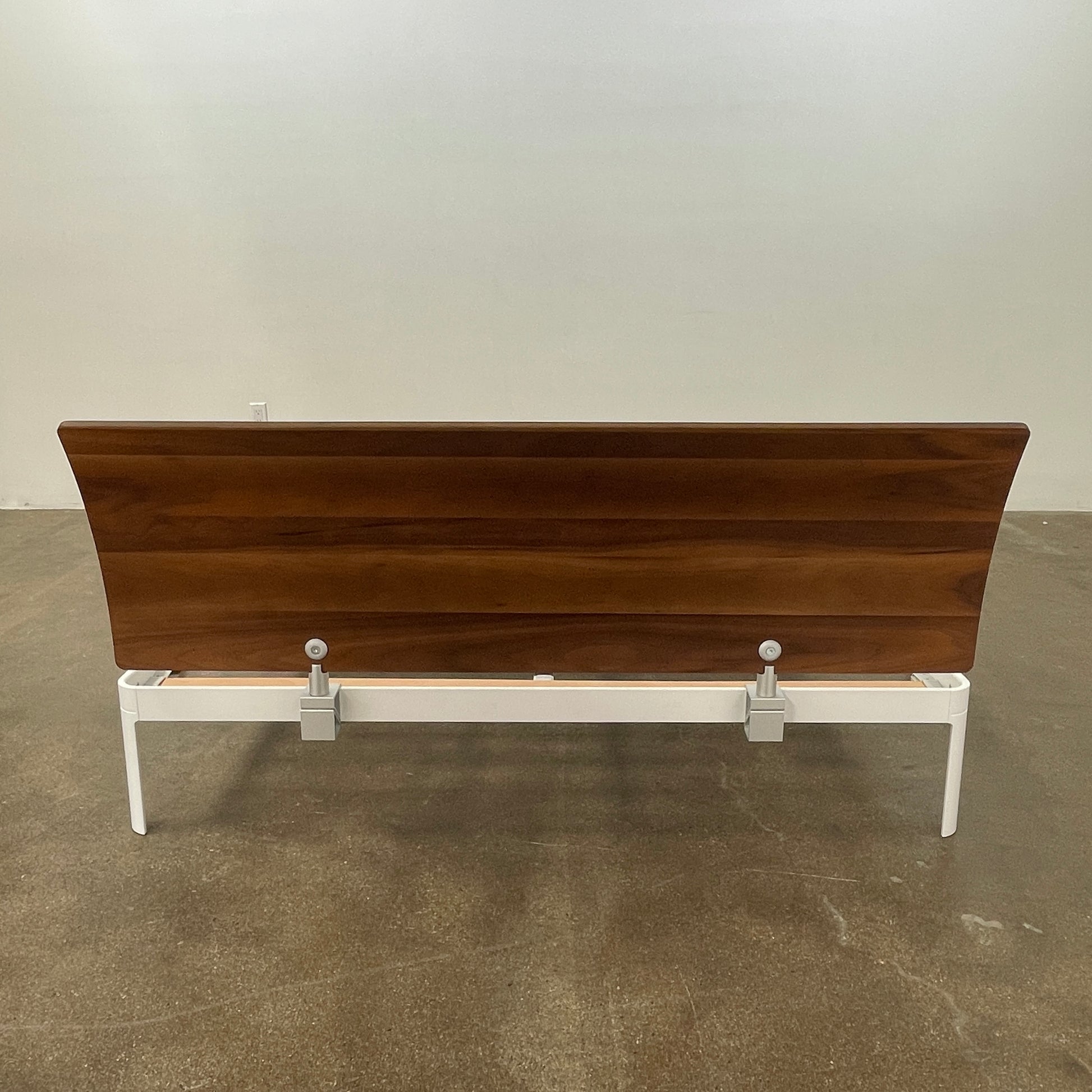 The DWR Min Queen Size Bed by Luciano Bertoncini showcases a metal frame with a sophisticated wooden headboard and slatted wooden base, elegantly placed against a plain white background.