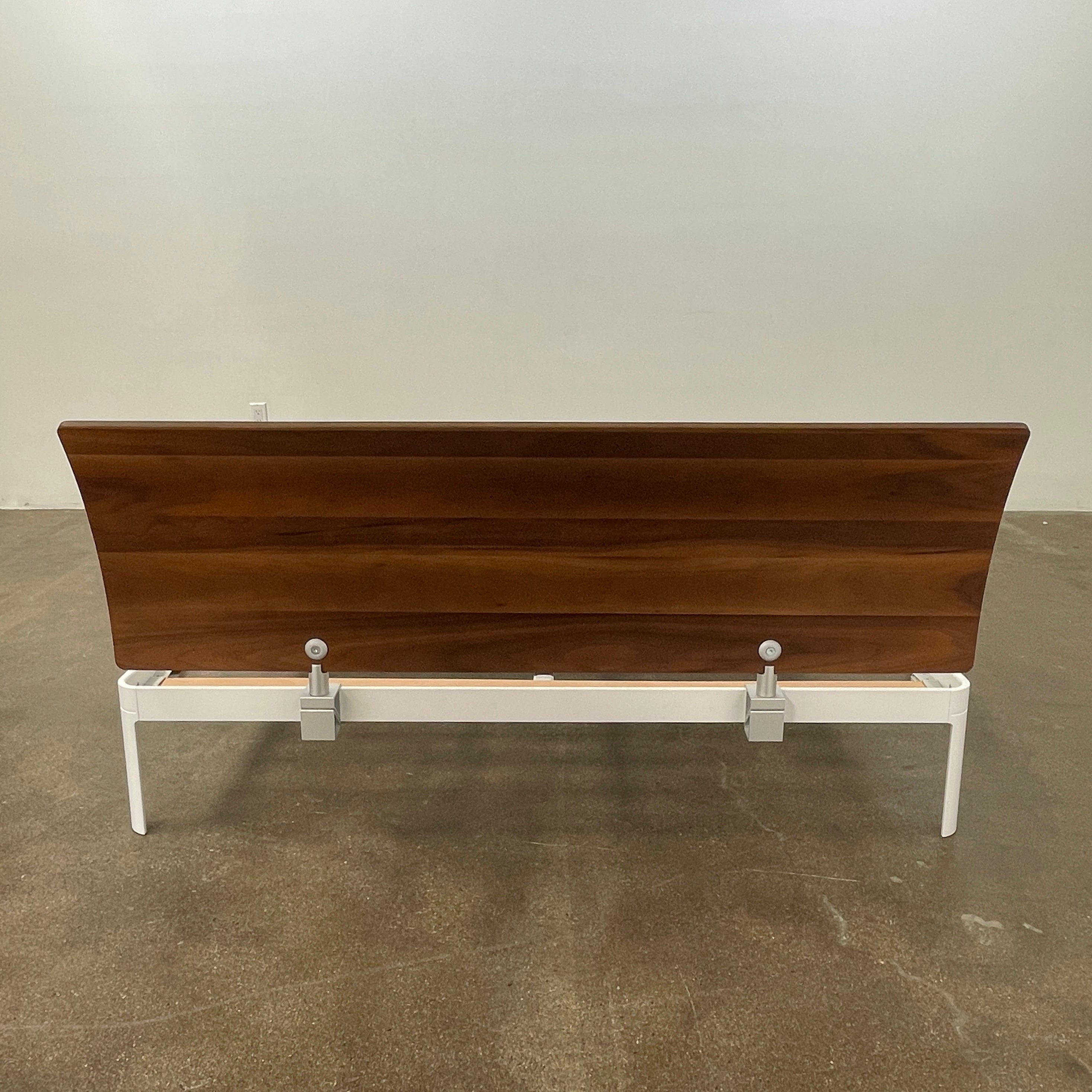 The DWR Min Queen Size Bed by Luciano Bertoncini showcases a metal frame with a sophisticated wooden headboard and slatted wooden base, elegantly placed against a plain white background.