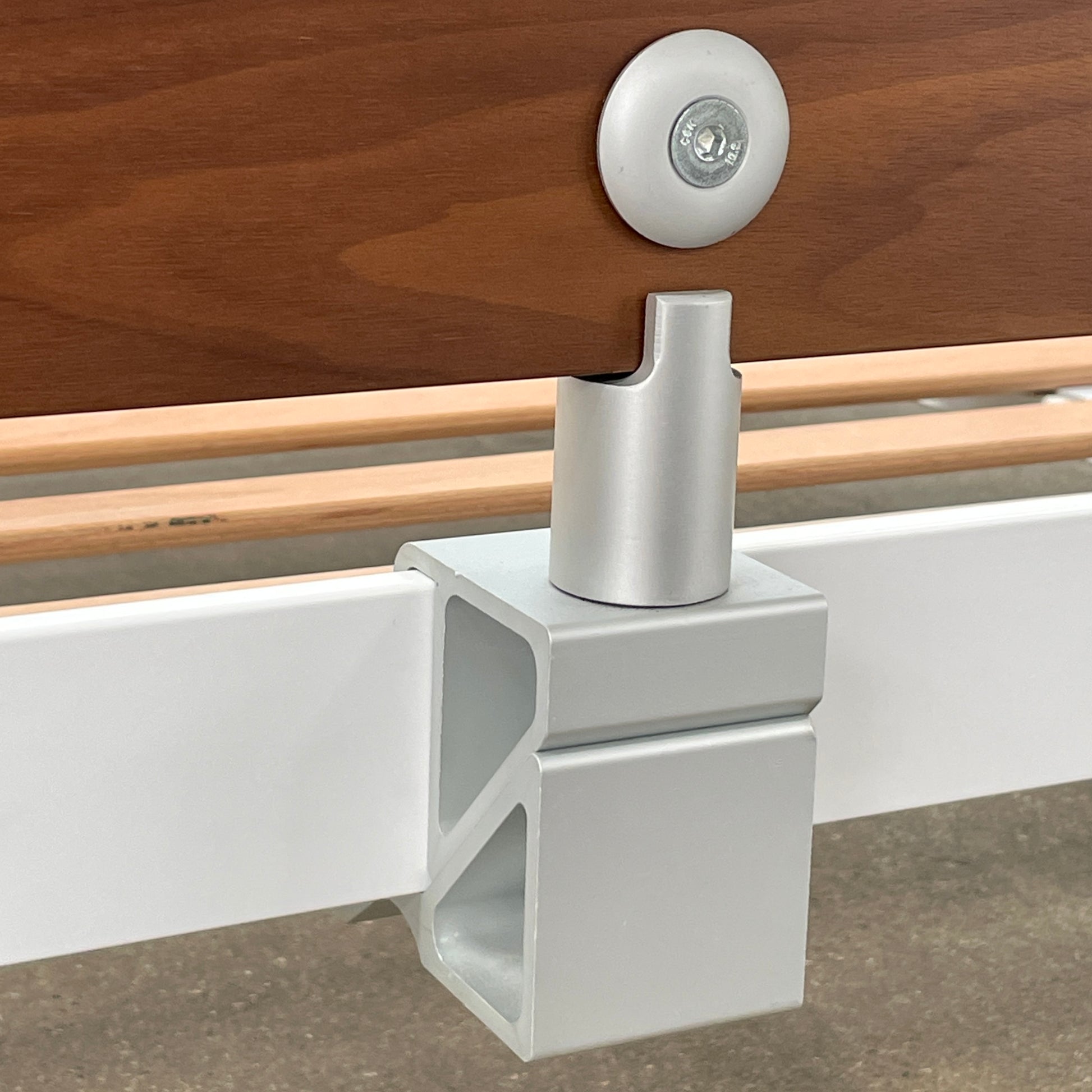 The DWR Min Queen Size Bed by Luciano Bertoncini showcases a metal frame with a sophisticated wooden headboard and slatted wooden base, elegantly placed against a plain white background.