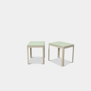 Two DWR Min Night Tables in green from the Modern Resale Min Collection, designed by an Italian designer, are set against a white background.