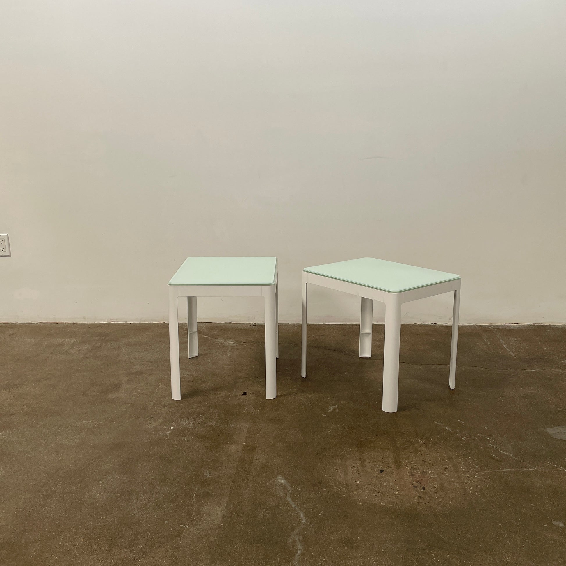 Two DWR Min Night Tables in green from the Modern Resale Min Collection, designed by an Italian designer, are set against a white background.