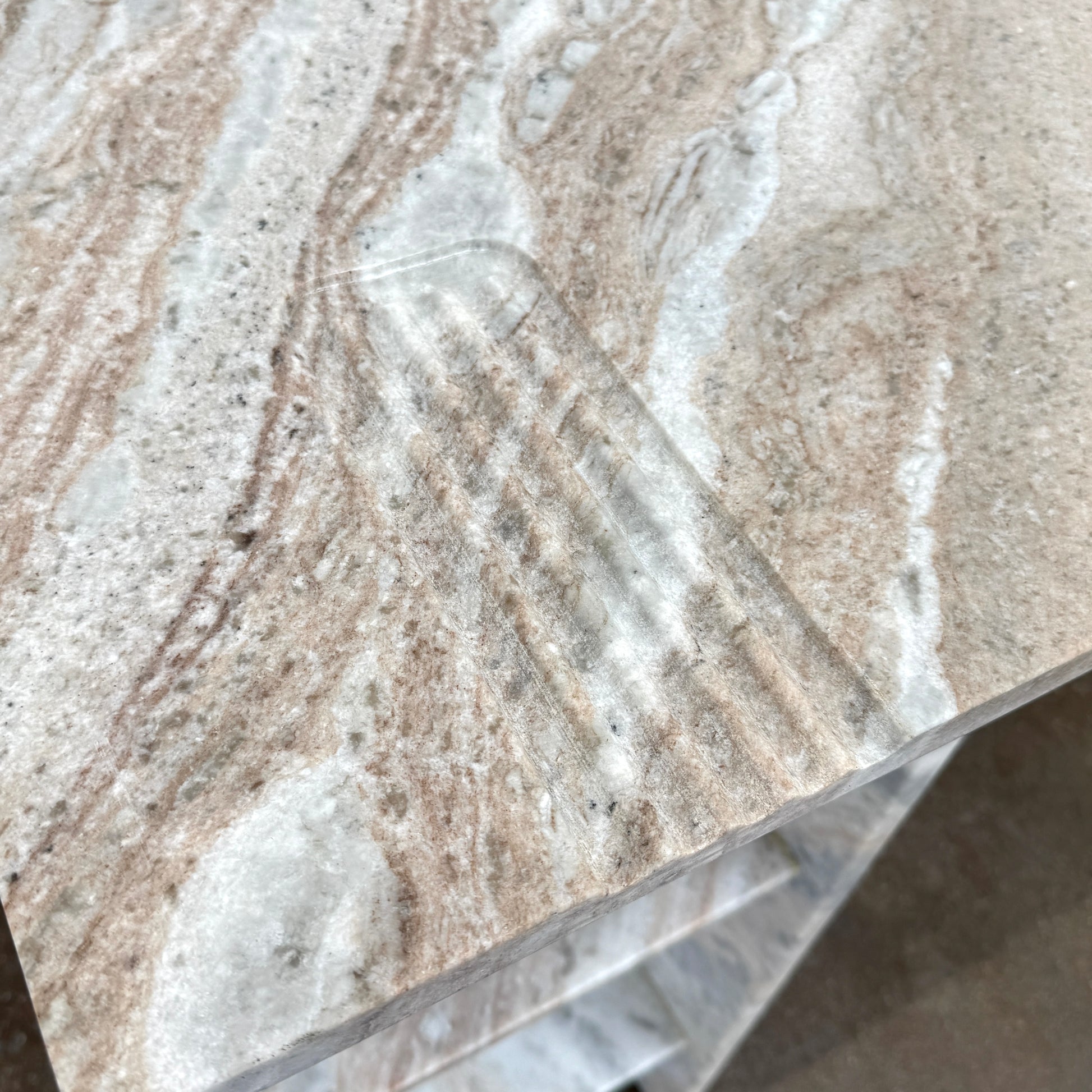 The CB2 Hera Torrento Brown Marble Desk with Shelves features two side panels and two open left corner shelves, showcasing a light gray and beige pattern inspired by Torrento brown marble.