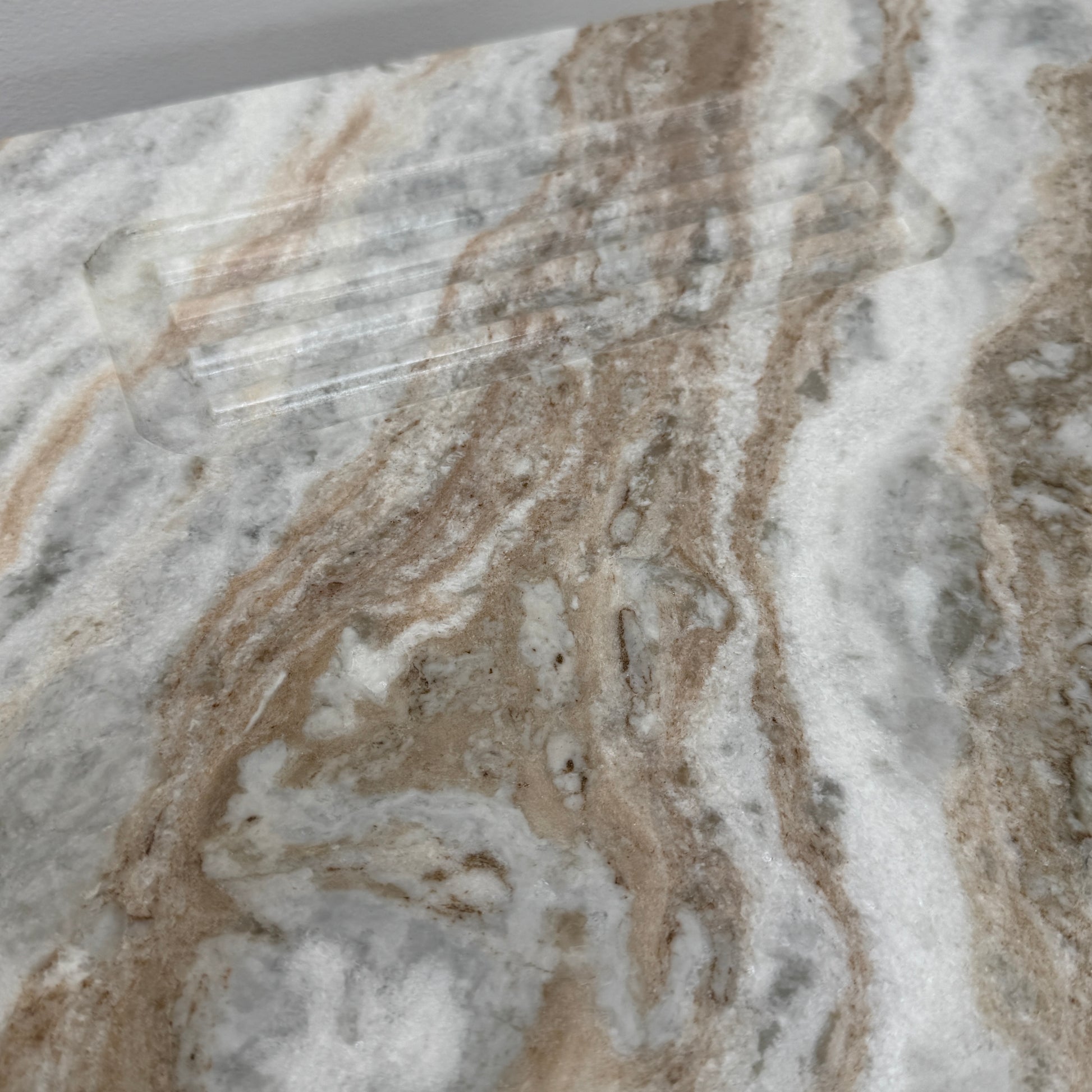 The CB2 Hera Torrento Brown Marble Desk with Shelves features two side panels and two open left corner shelves, showcasing a light gray and beige pattern inspired by Torrento brown marble.