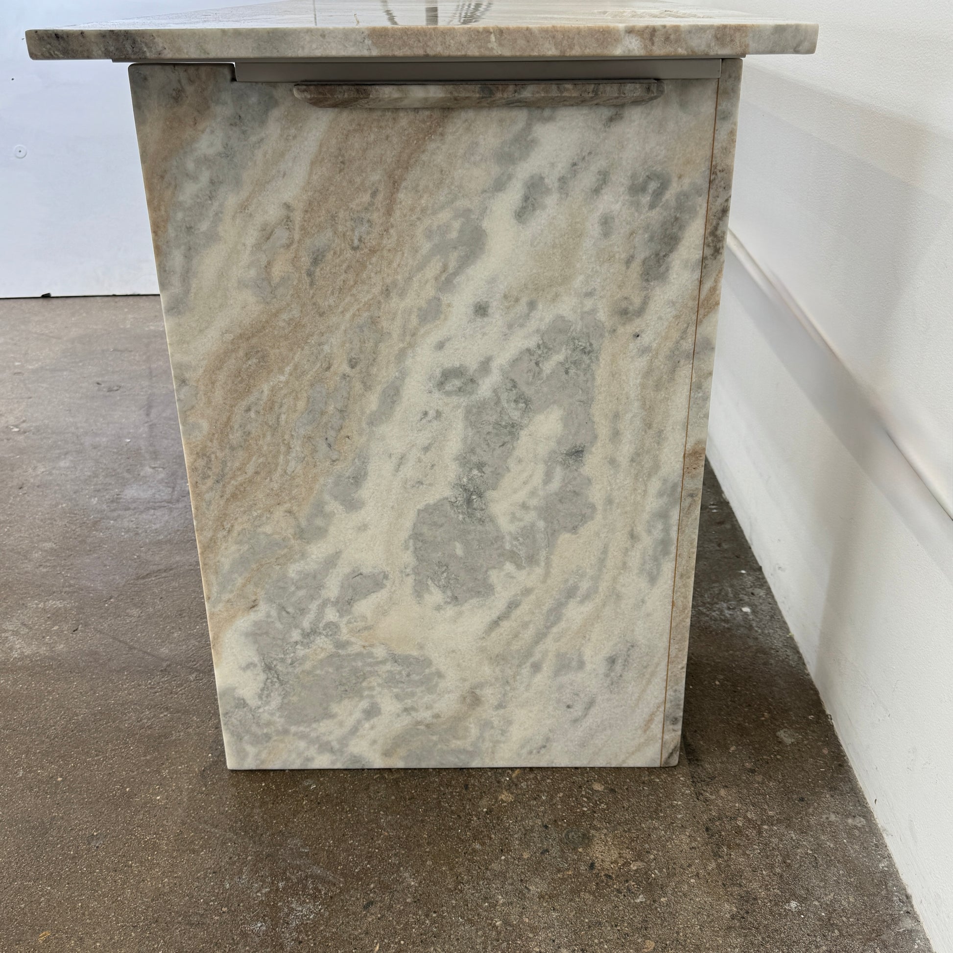 The CB2 Hera Torrento Brown Marble Desk with Shelves features two side panels and two open left corner shelves, showcasing a light gray and beige pattern inspired by Torrento brown marble.