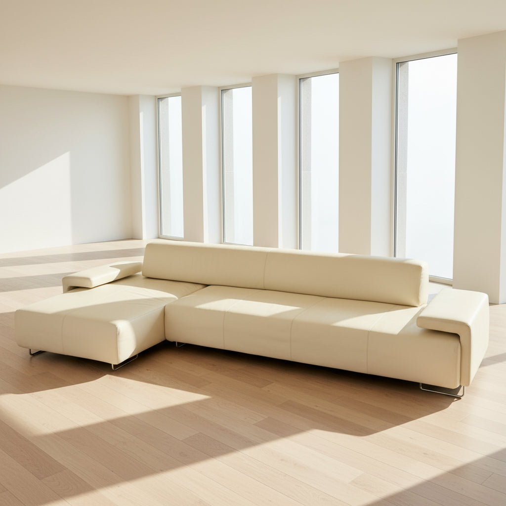 The Moroso Lowland Sectional Sofa by Moroso features beige leather, a low backrest, wide armrests, and a right-side chaise lounge inspired by Patricia Urquiola’s modern design, set against a plain white background.