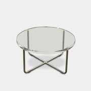 The Minotti Lucite Accent Table boasts a round glass top with a chrome metal frame and crossed base, capturing the Italian elegance synonymous with Minotti's design.
