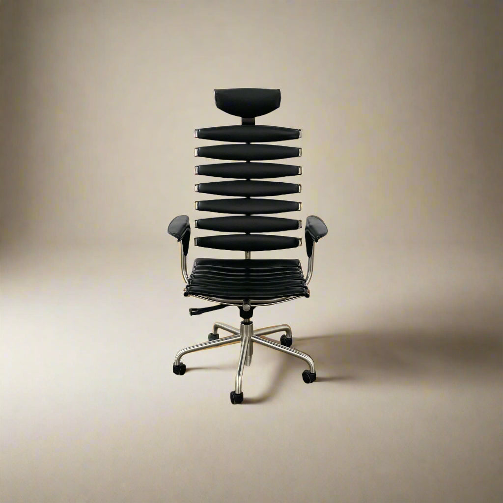 The De Sede DS-2100 High-Backed Executive Office Chair features a segmented black leather backrest, adjustable armrests, headrest, and a sturdy metal swivel base with five caster wheels.