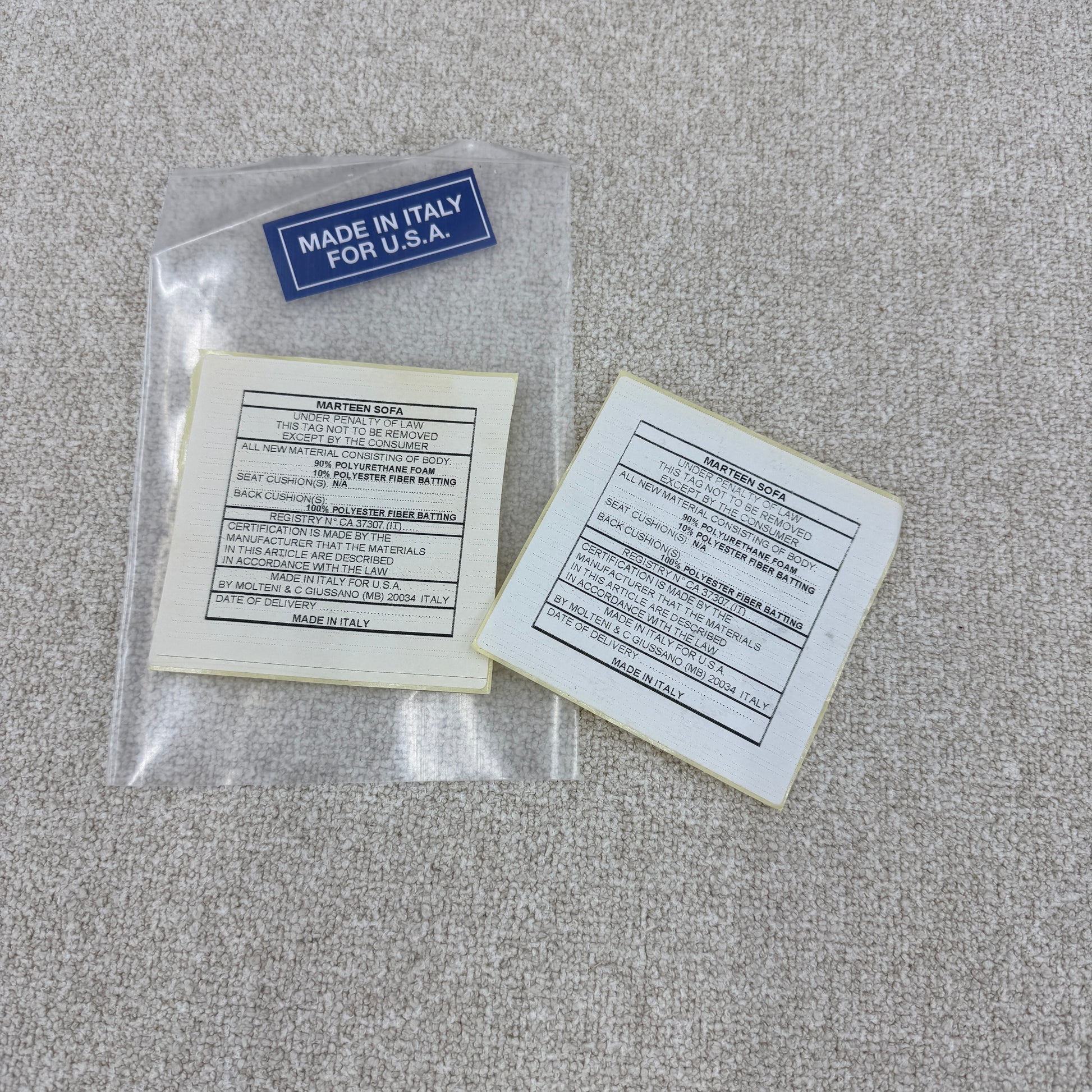 The Molteni & C Marteen Sofa is a modern beige sofa with wide armrests and two rectangular brown back cushions, featuring linen blend upholstery. Shown from the front on a white background.