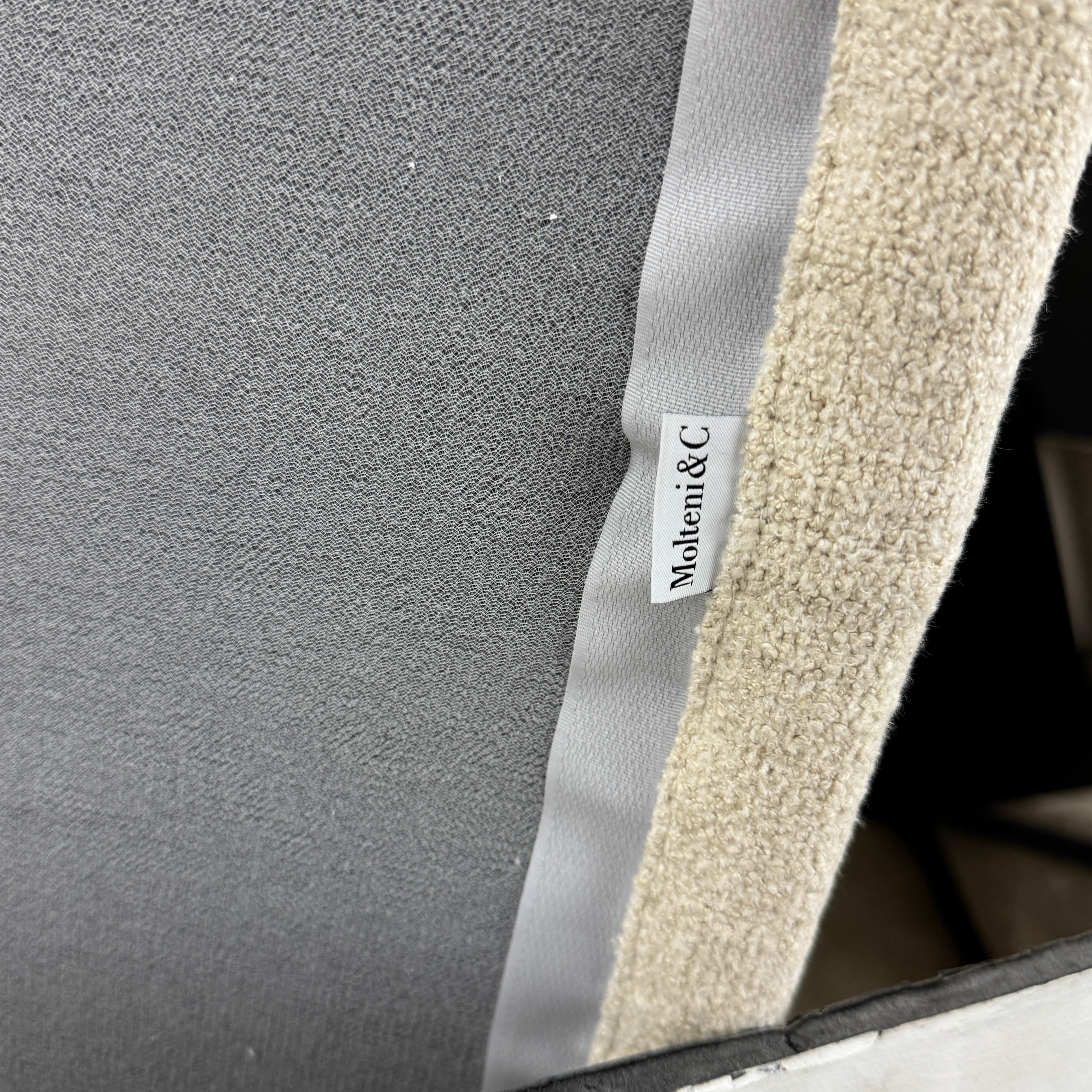 The Molteni & C Marteen Sofa is a modern beige sofa with wide armrests and two rectangular brown back cushions, featuring linen blend upholstery. Shown from the front on a white background.