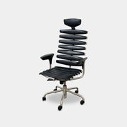 The De Sede DS-2100 High-Backed Executive Office Chair features a segmented black leather backrest, adjustable armrests, headrest, and a sturdy metal swivel base with five caster wheels.