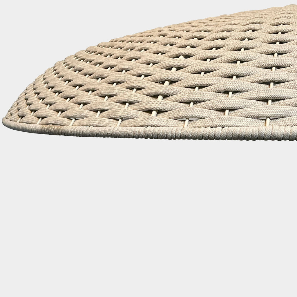A Paola Lenti Mogambo Parasol on a white stand, designed by Paola Lenti.
