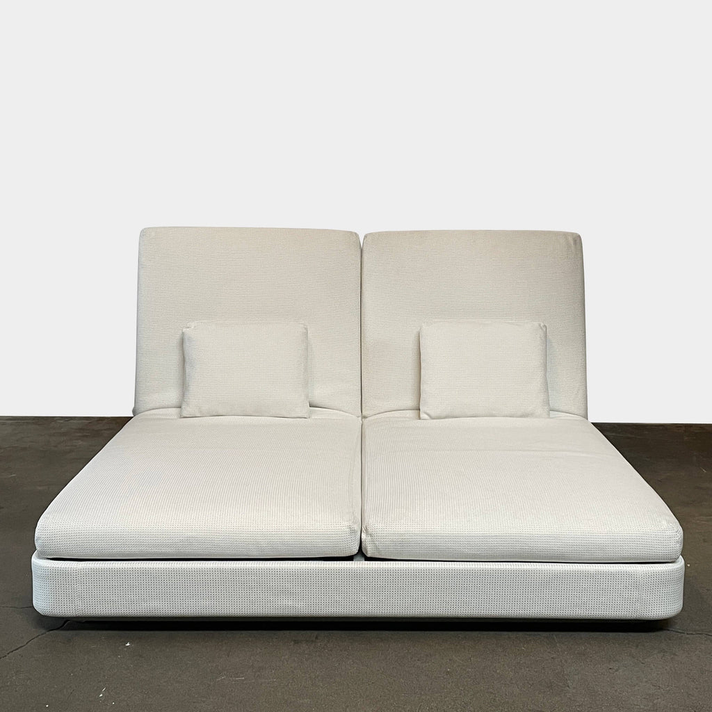 A Paola Lenti Cove Double Sunbed, in white, with two pillows on top of it.