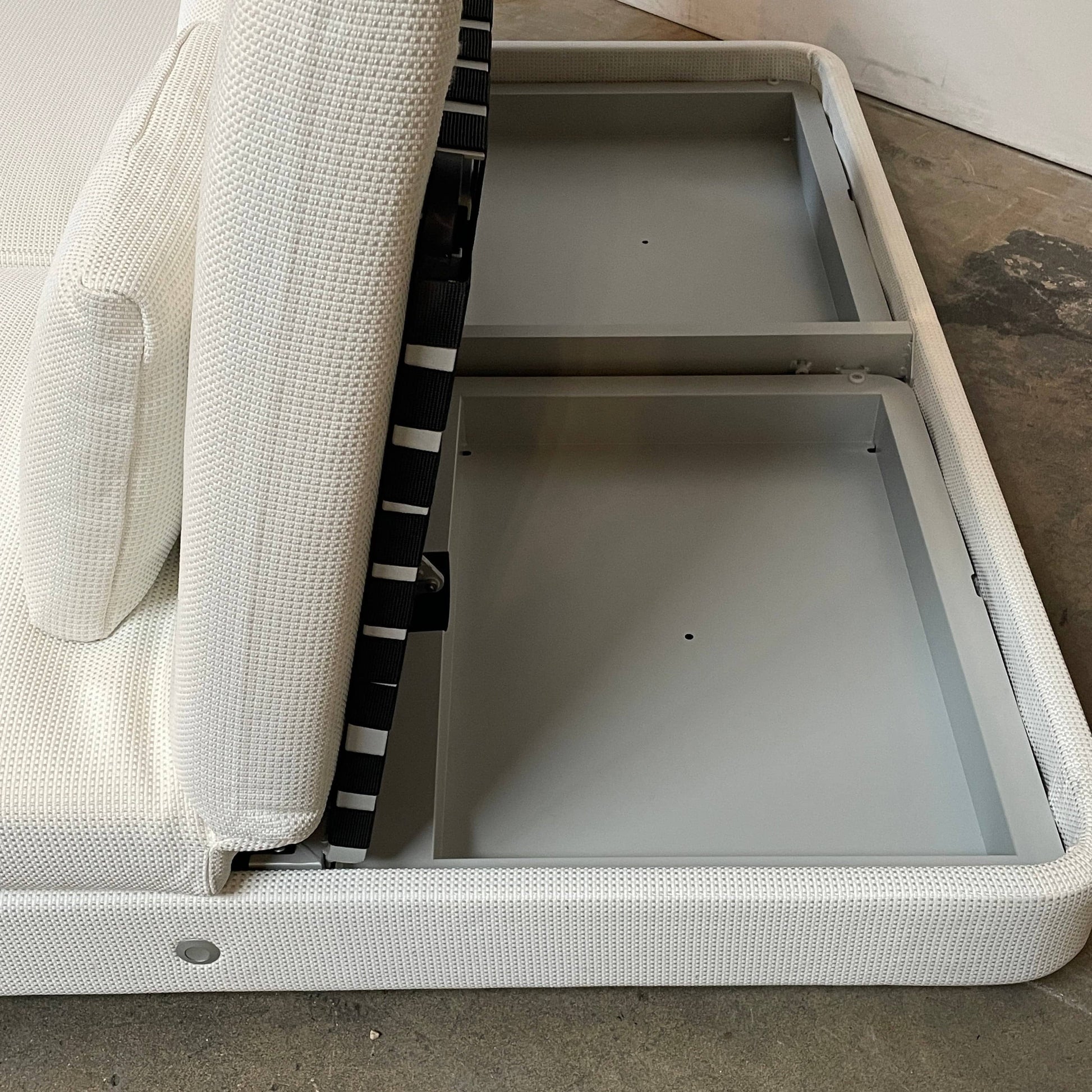 An adjustable white Paola Lenti Cove Double Sunbed by Paola Lenti features two separate reclining mattresses and matching pillows, perfect for outdoor lounging.