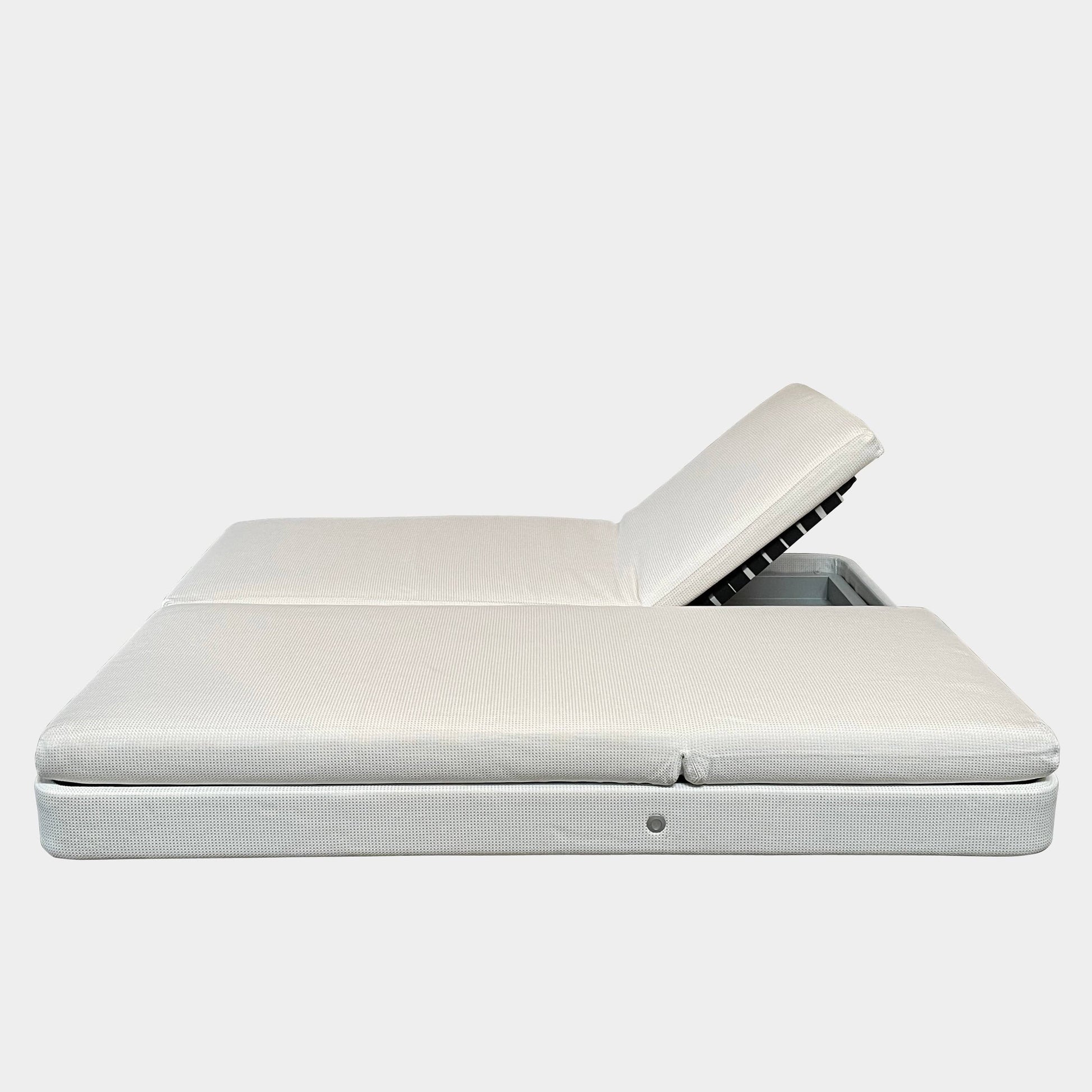An adjustable white Paola Lenti Cove Double Sunbed by Paola Lenti features two separate reclining mattresses and matching pillows, perfect for outdoor lounging.