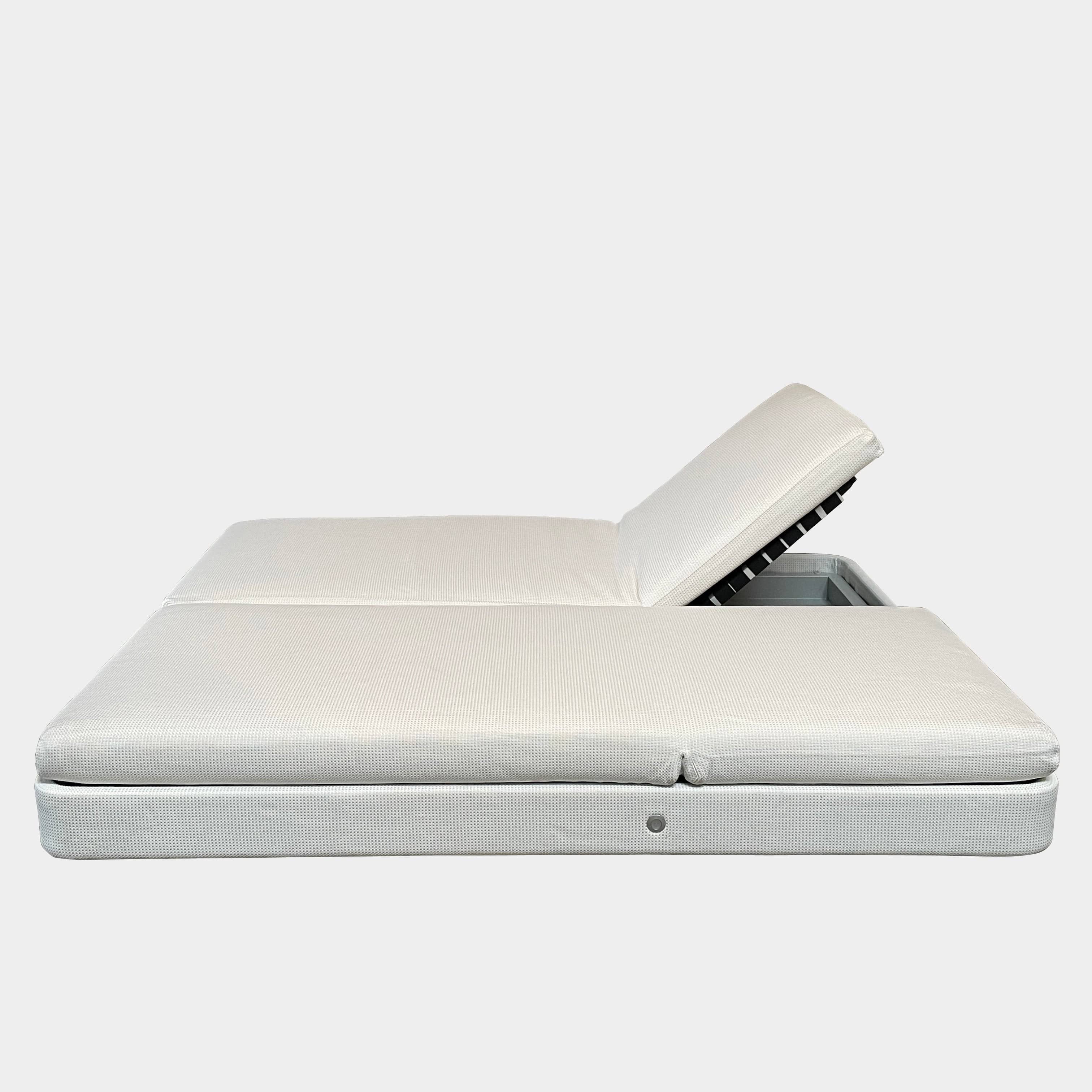 An adjustable white Paola Lenti Cove Double Sunbed by Paola Lenti features two separate reclining mattresses and matching pillows, perfect for outdoor lounging.