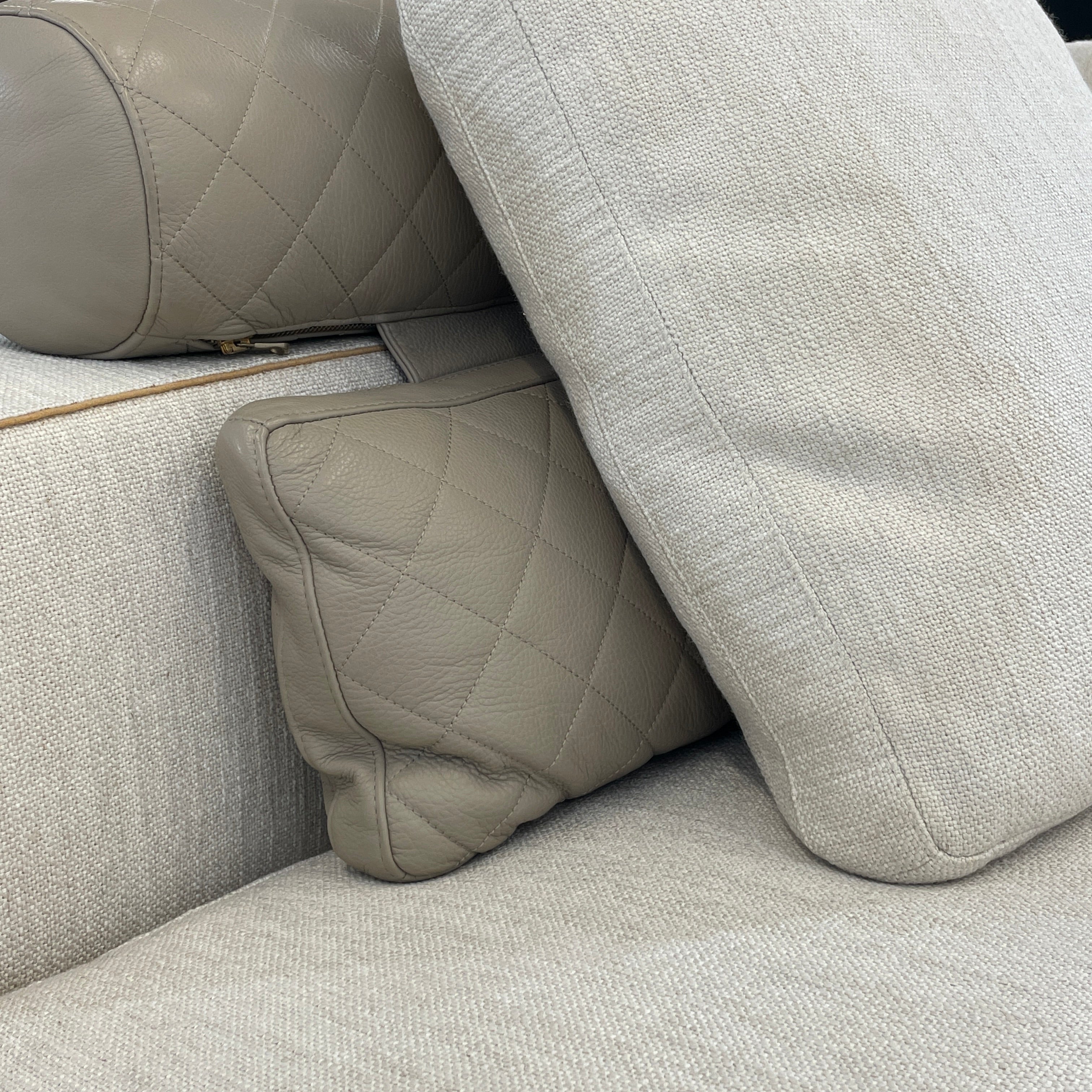 The Minotti Leonard 3 Piece Sectional by Minotti features an L-shaped beige design with three seat sections, multiple back and side cushions, and a right-side chaise lounge—ideal for an elegant living space—shown on a plain white background.