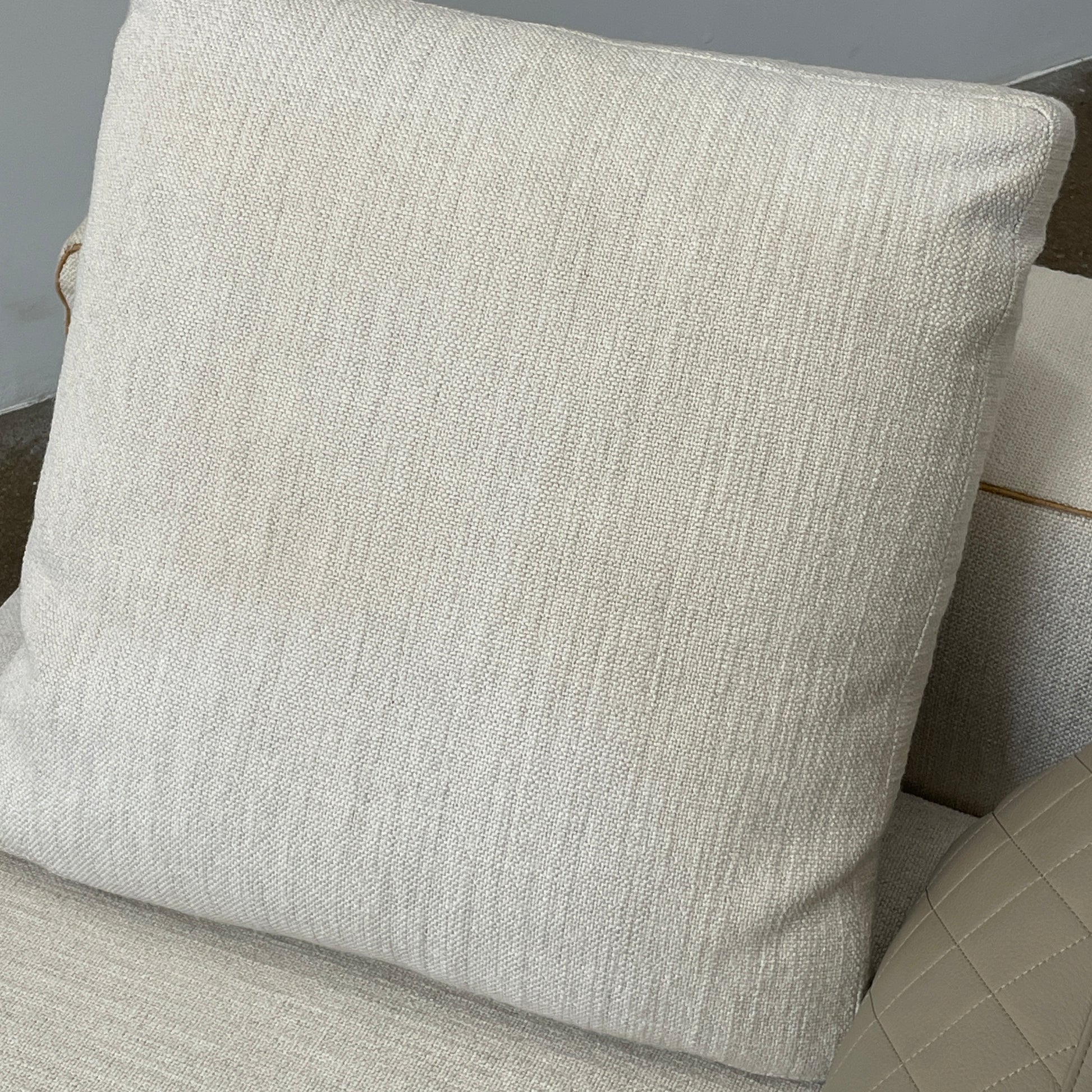 The Minotti Leonard 3 Piece Sectional by Minotti features an L-shaped beige design with three seat sections, multiple back and side cushions, and a right-side chaise lounge—ideal for an elegant living space—shown on a plain white background.