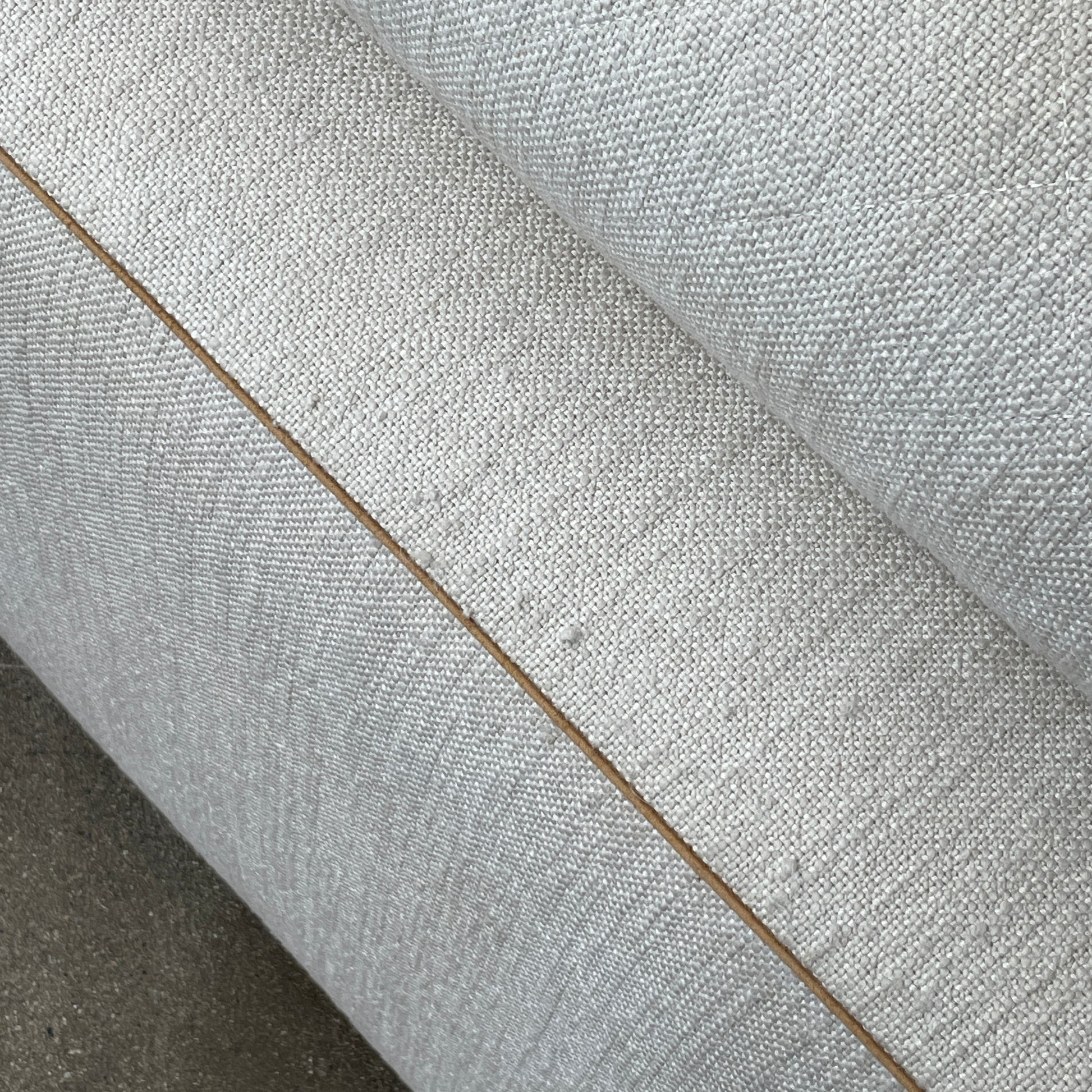 The Minotti Leonard 3 Piece Sectional by Minotti features an L-shaped beige design with three seat sections, multiple back and side cushions, and a right-side chaise lounge—ideal for an elegant living space—shown on a plain white background.