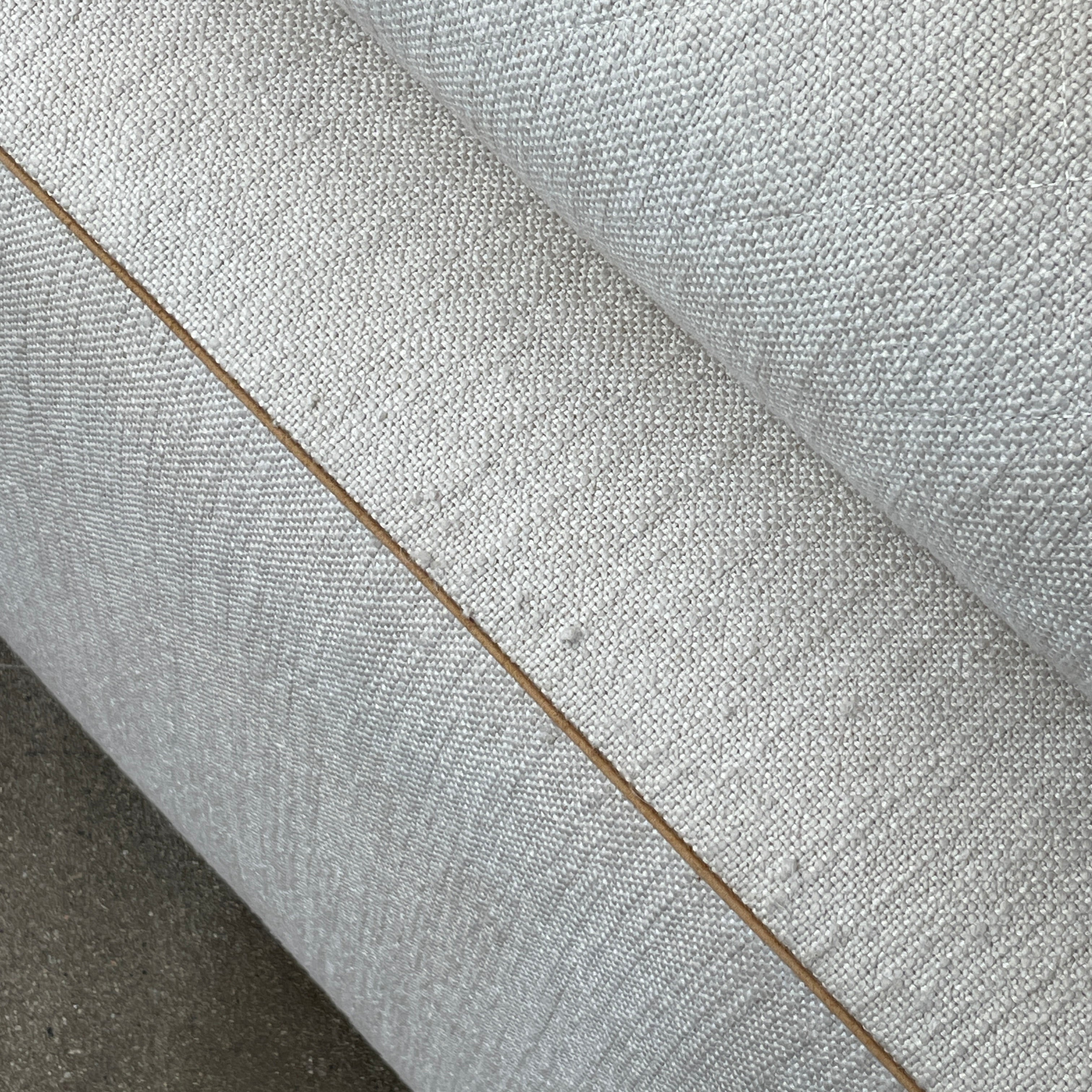 The Minotti Leonard 3 Piece Sectional by Minotti features an L-shaped beige design with three seat sections, multiple back and side cushions, and a right-side chaise lounge—ideal for an elegant living space—shown on a plain white background.