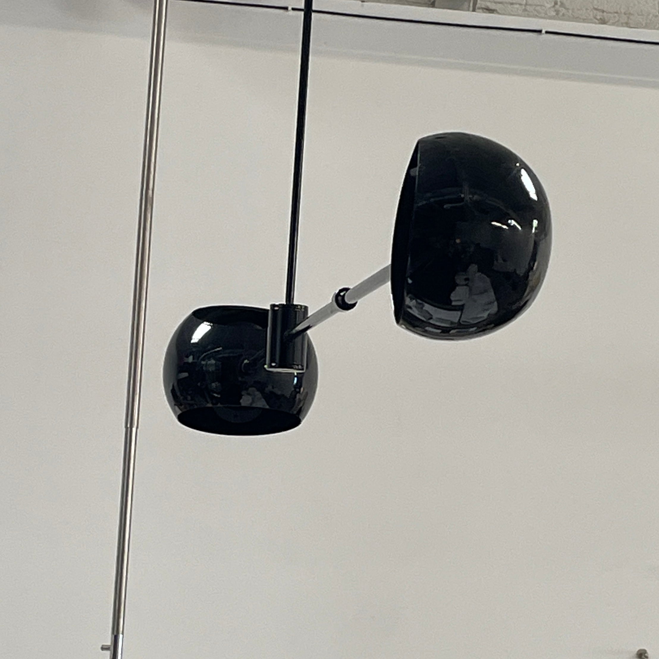 The David Weeks Studio Abaca Suspension Light is a custom-made, black, modern hanging fixture with two spherical bulbs. Crafted from powder-coated steel, it elegantly suspends from ceilings with exposed beams to add sophistication to any space.