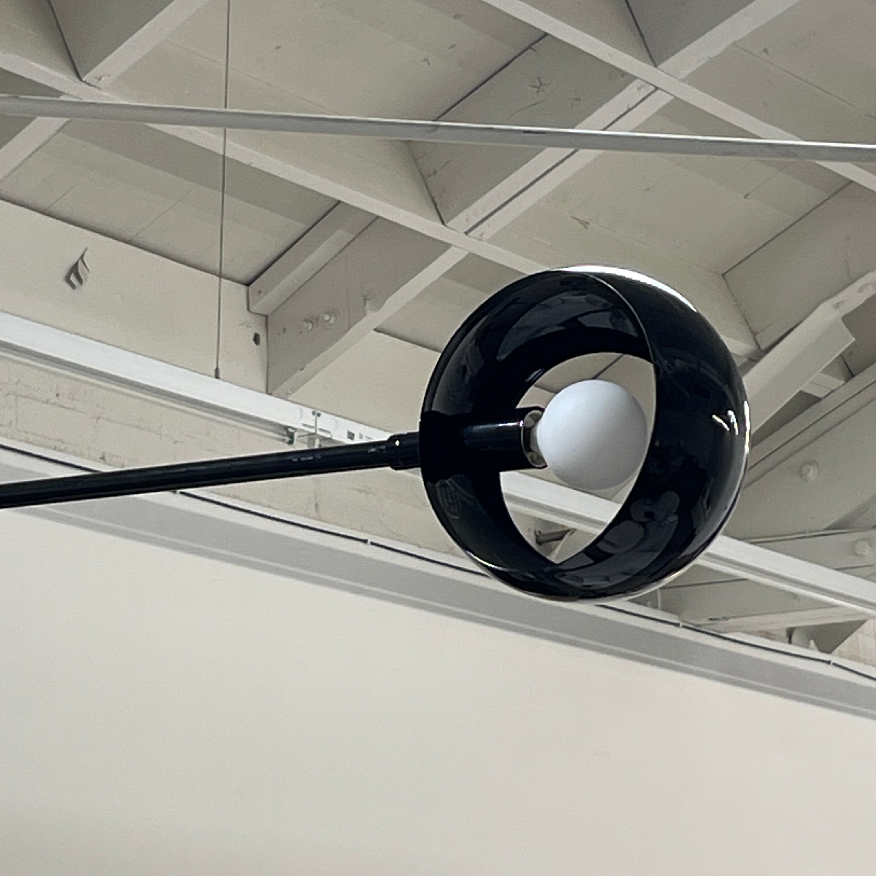 The David Weeks Studio Abaca Suspension Light is a custom-made, black, modern hanging fixture with two spherical bulbs. Crafted from powder-coated steel, it elegantly suspends from ceilings with exposed beams to add sophistication to any space.