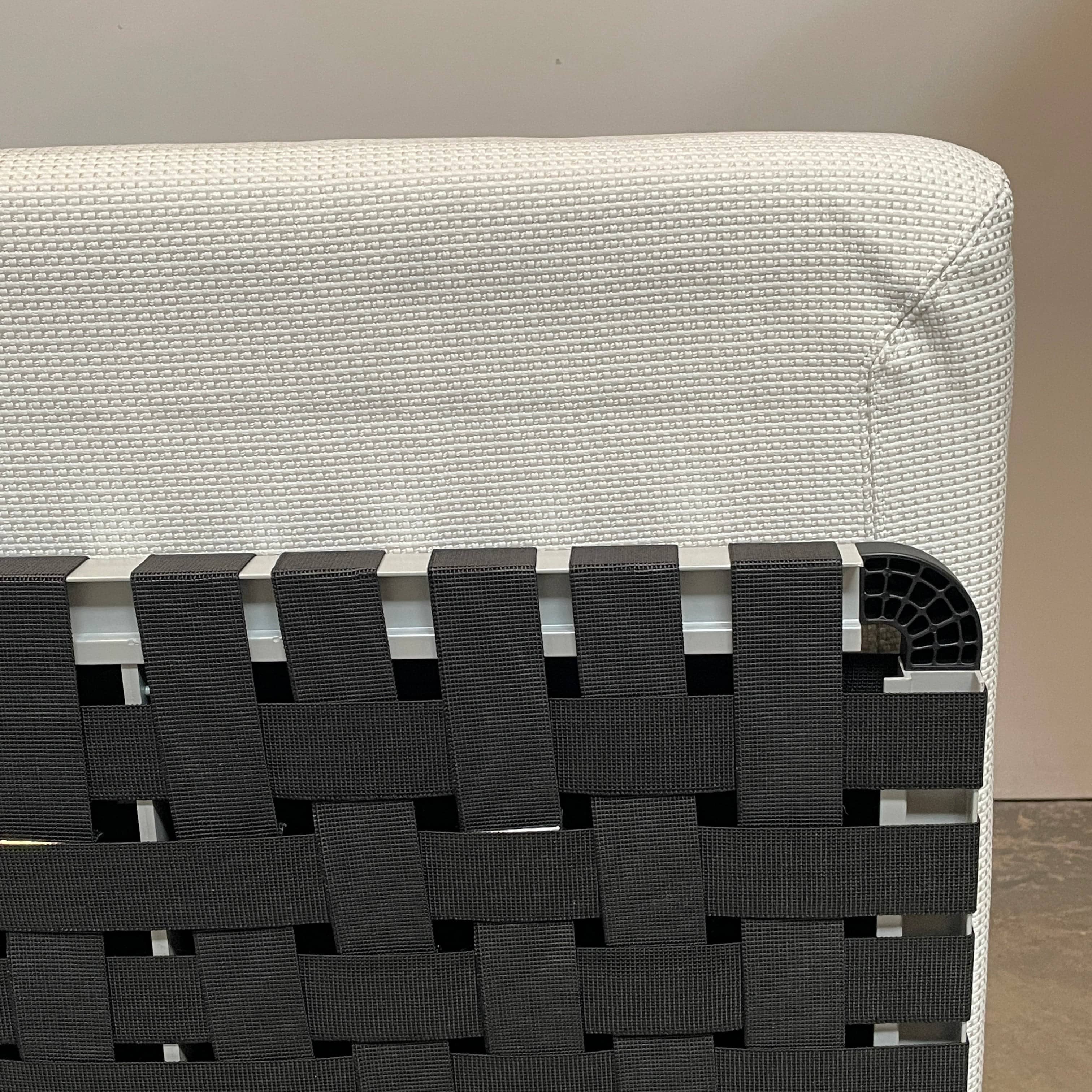 An adjustable white Paola Lenti Cove Double Sunbed by Paola Lenti features two separate reclining mattresses and matching pillows, perfect for outdoor lounging.