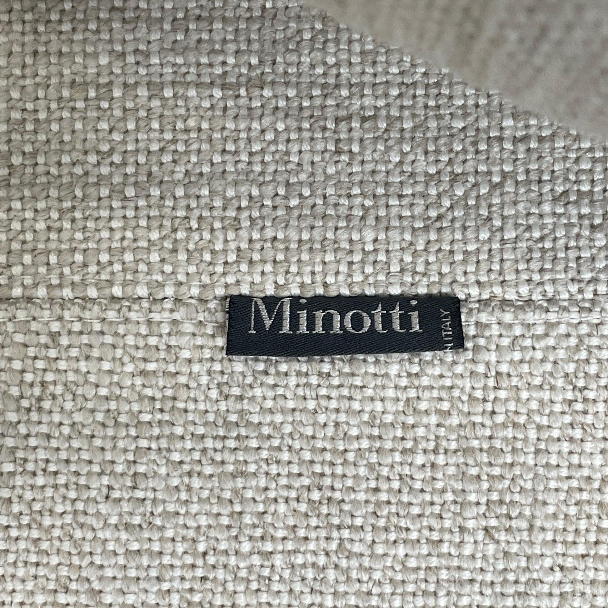 The Minotti Leonard 3 Piece Sectional by Minotti features an L-shaped beige design with three seat sections, multiple back and side cushions, and a right-side chaise lounge—ideal for an elegant living space—shown on a plain white background.