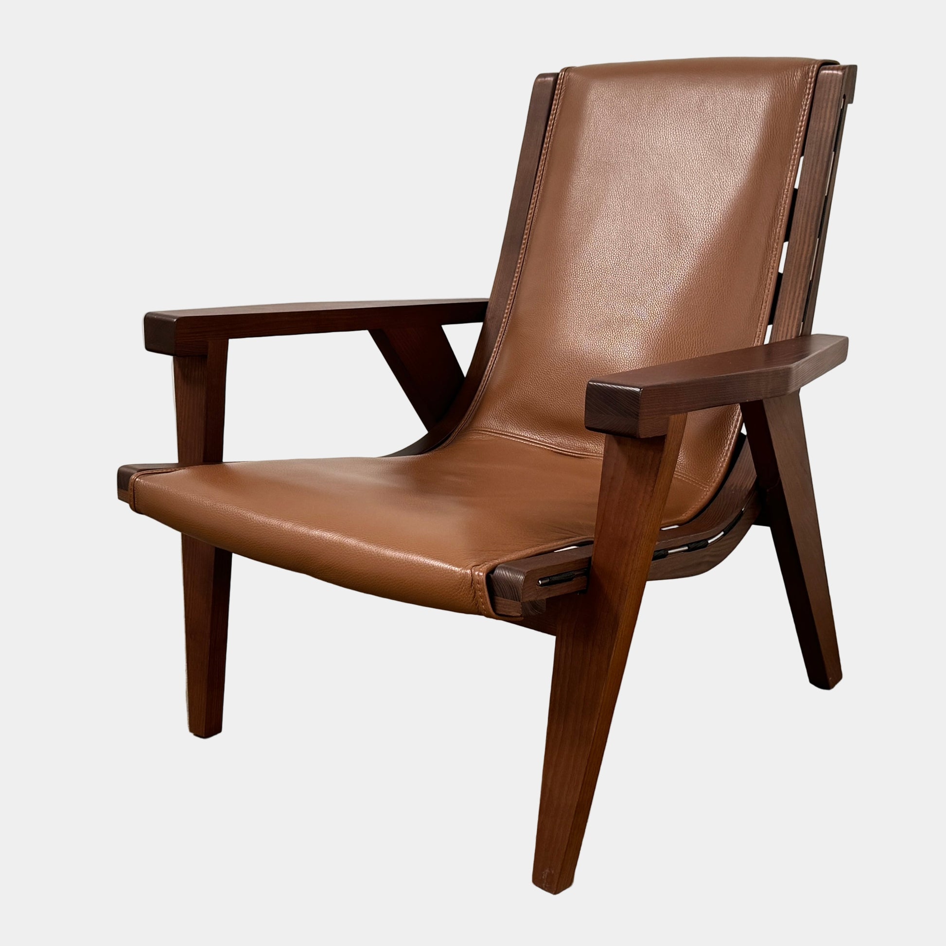 A contemporary B&B Italia JJ Armchair with brown leather seat and backrest, angular armrests, and a dark wooden frame, designed by Antonio Citterio. Set against a plain white background.