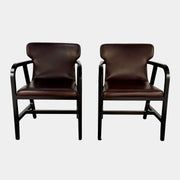 A pair of Maxalto Fulgens Armchair set (2) by Maxalto, in dark brown leather with black wooden frames, are placed side by side against a plain white background.